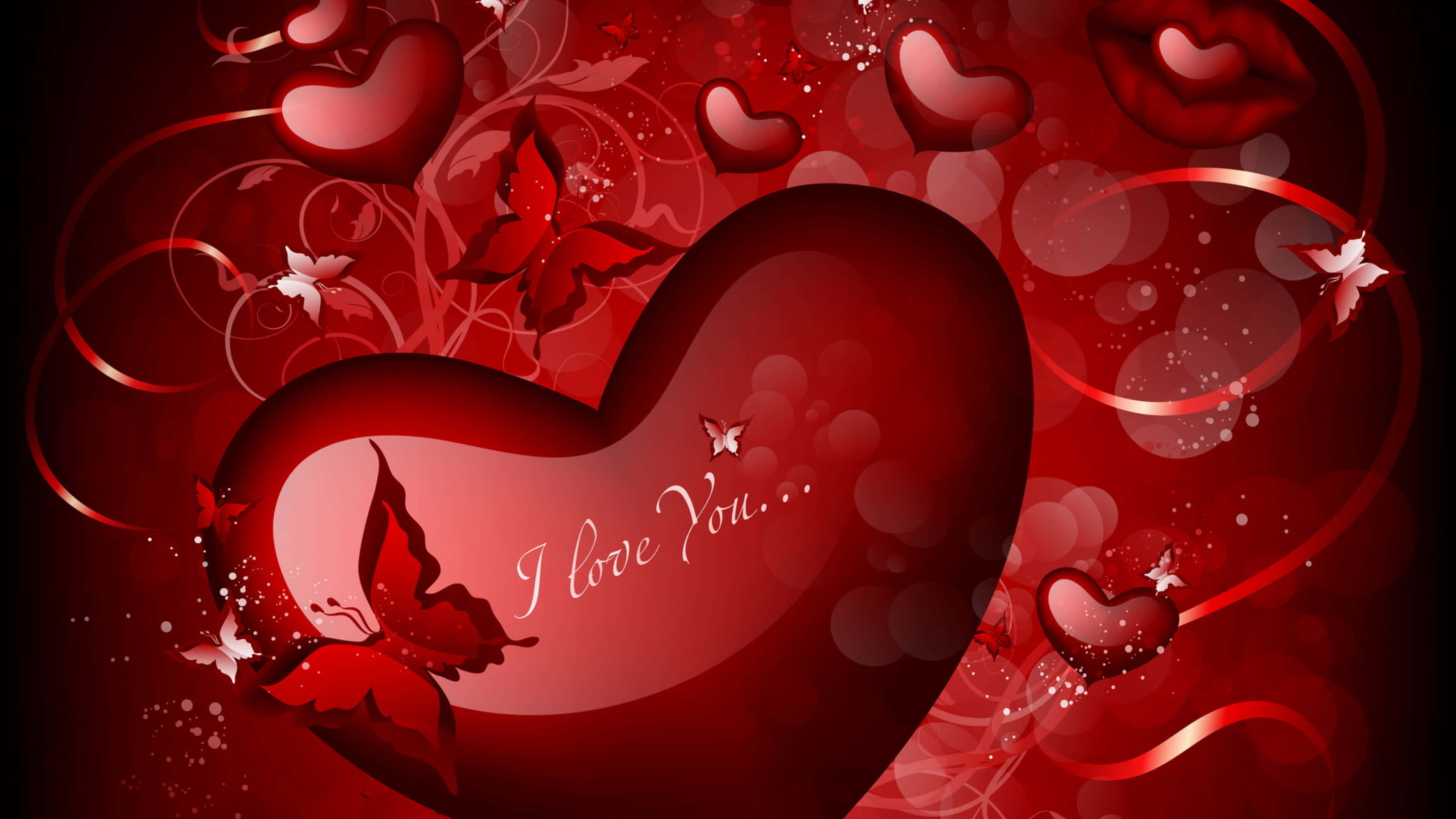 4K Love 桌布 壁紙 — 一個帶有 'I love you' 文字的亮面紅色心形，被旋轉的絲帶、蝴蝶和較小的愛心環繞，背景是深紅色的散景。
