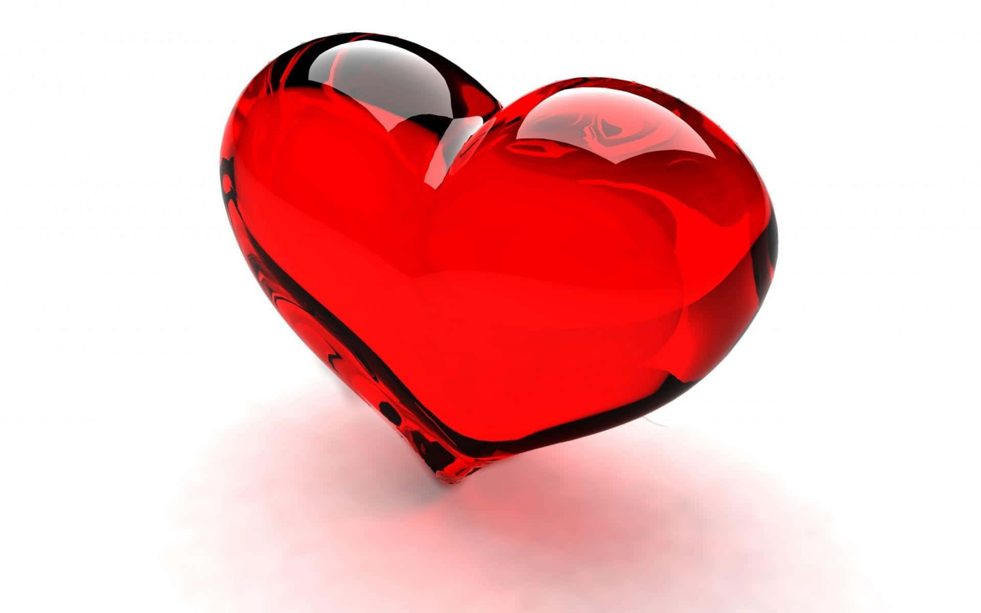 3d Heart 桌布 壁紙 — 一個帶有反光高光的亮面紅色玻璃心臟，孤立地放在白色表面上，投下柔和的陰影。