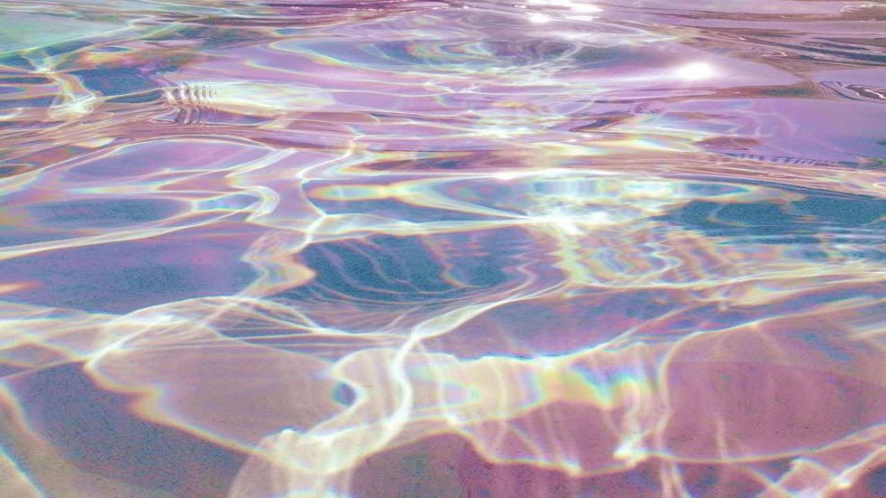 一個帶有彩虹色水面的泳池 壁紙