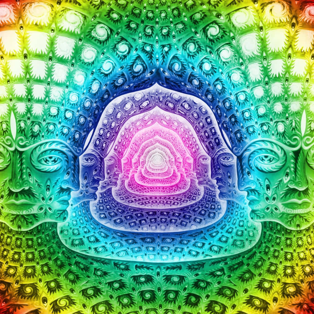 Trippy Fractals 桌布 壁紙 — 一個帶有彩虹色調和重複眼睛圖案的迷幻分形曼陀羅，從中央發光的螺旋向外輻射。
