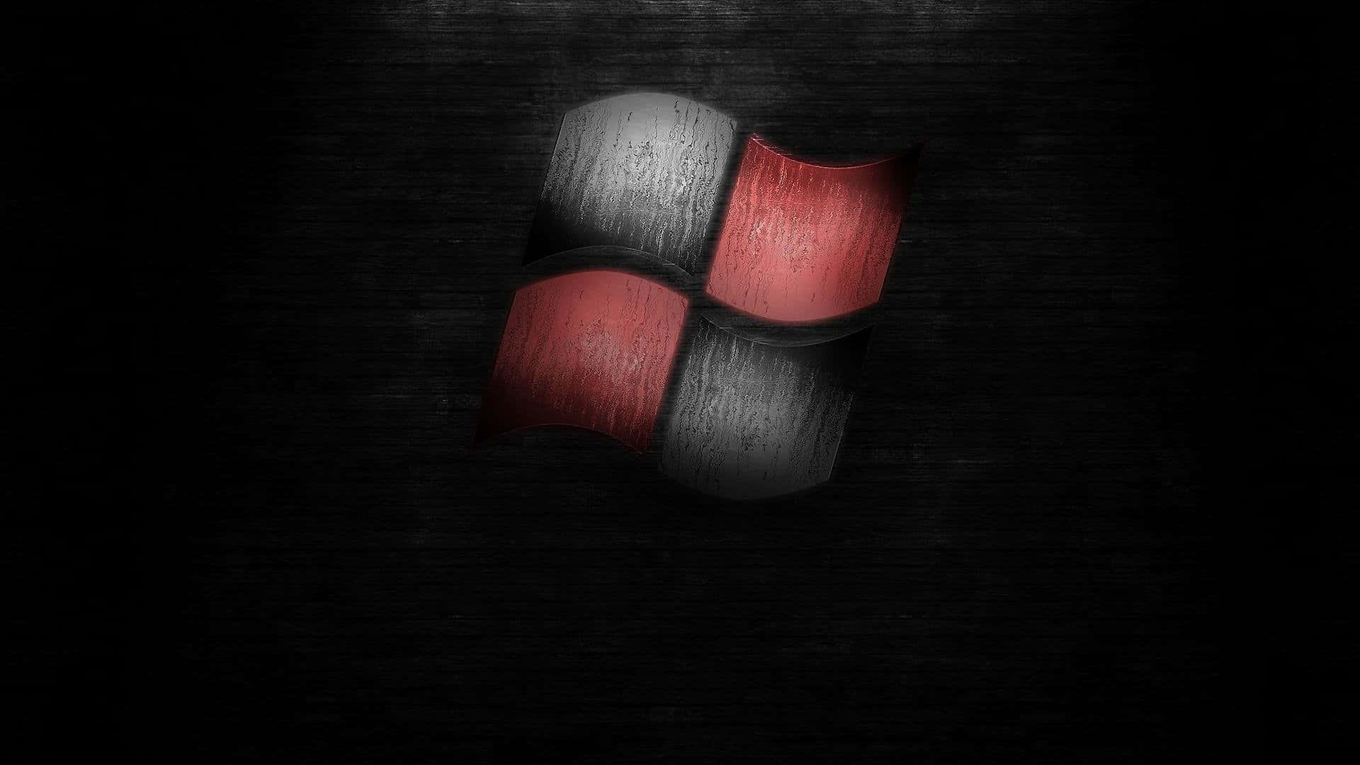 Black Windows 桌布 壁紙 — 一個帶有紅色和灰色面板的風化Windows標誌，在深色紋理背景上隱約發光。