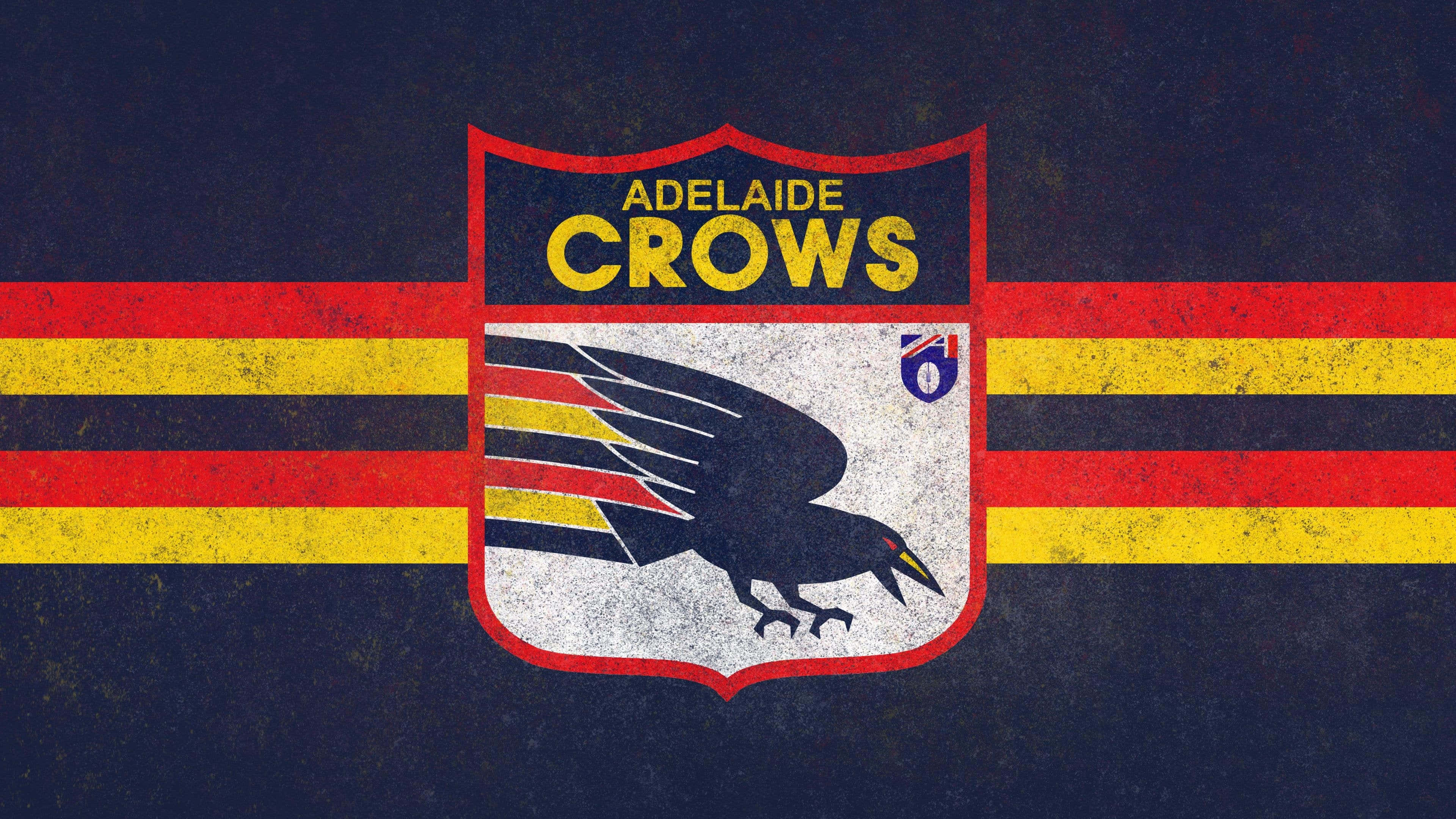 Adelaide 桌布 壁紙 — 一個復古的Adelaide Crows AFL標誌，在帶有紋理的深藍色背景上，盾牌上有一隻黑色的烏鴉，並有紅色和黃色條紋。
