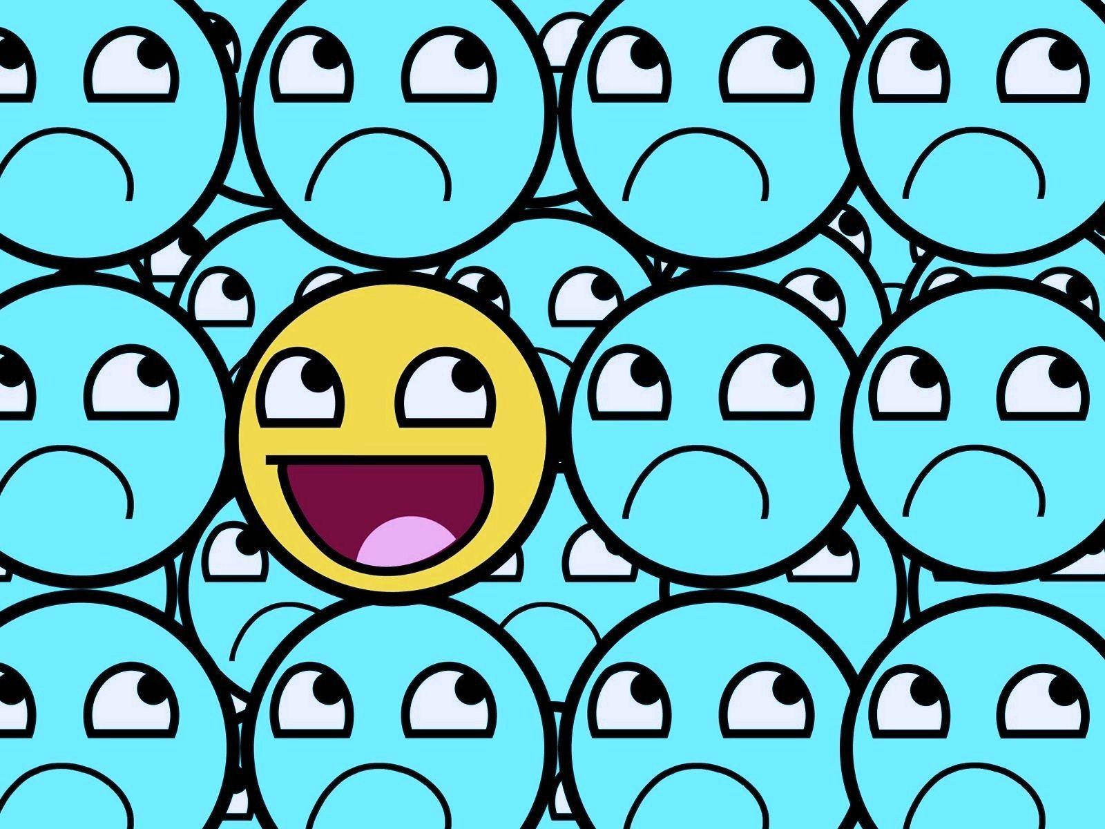 laughing emoji 桌布 壁紙 — 一個快樂的黃色表情符號在眾多嘴巴下垂的藍色悲傷表情符號中燦爛微笑。