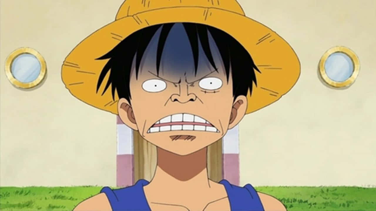 搞笑動漫GIF 桌布 壁紙 — 一個意志堅定的動漫男孩，黑髮戴著黃色草帽，咬緊牙關，表情兇狠。