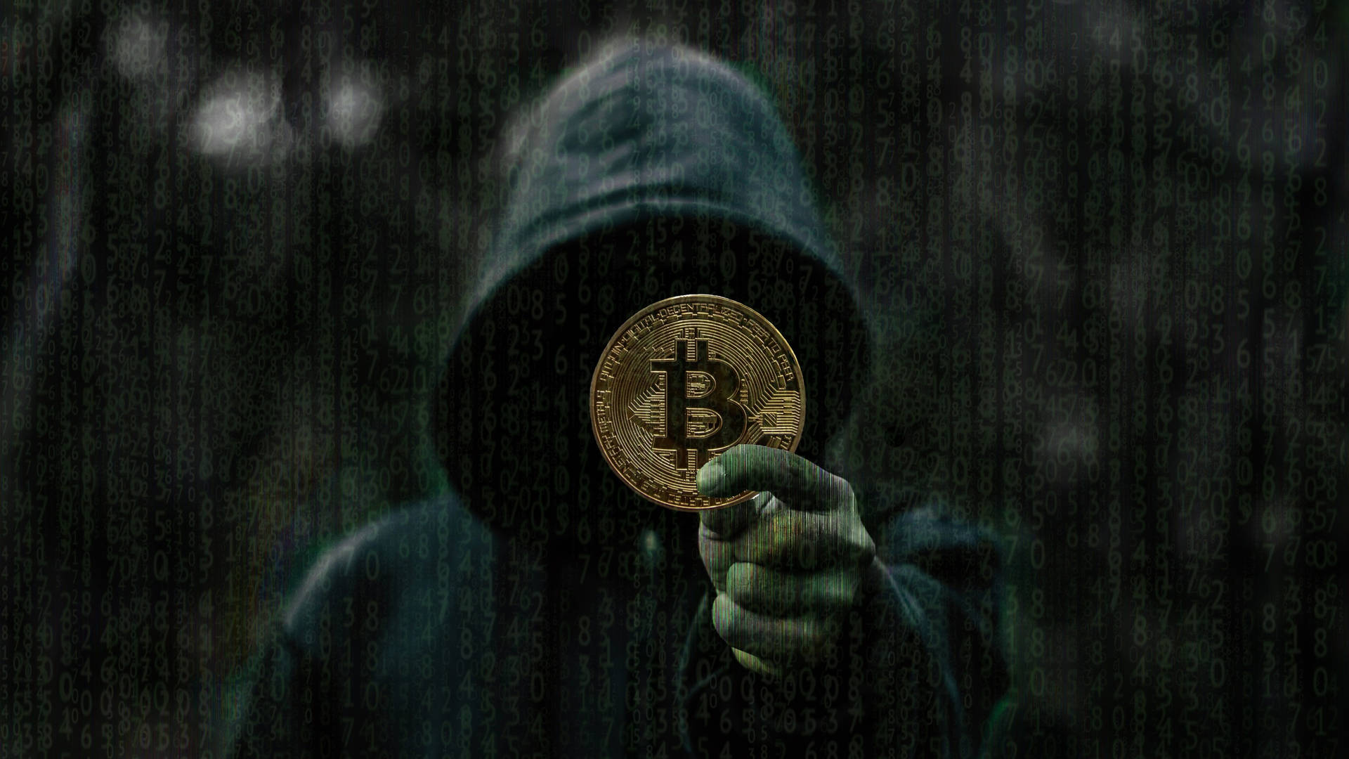匿名黑客在數碼暴雨中手持比特幣。 — 比特幣 壁紙