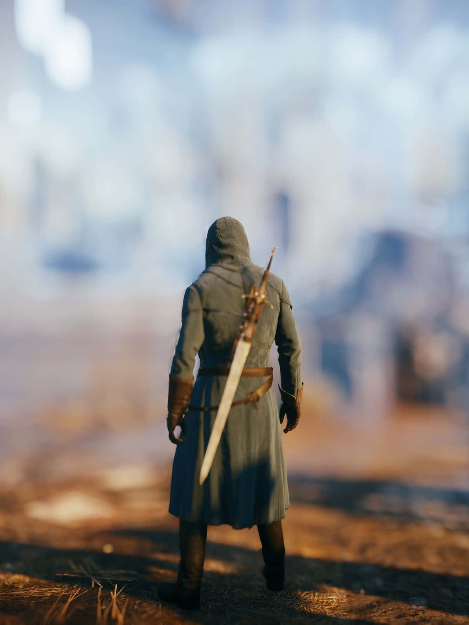Arno Dorian 桌布 壁紙 — 一個戴著兜帽的戰士，背上背著劍，獨自站在陽光明媚的田野中，凝視著遠處白雪皚皚的山脈。