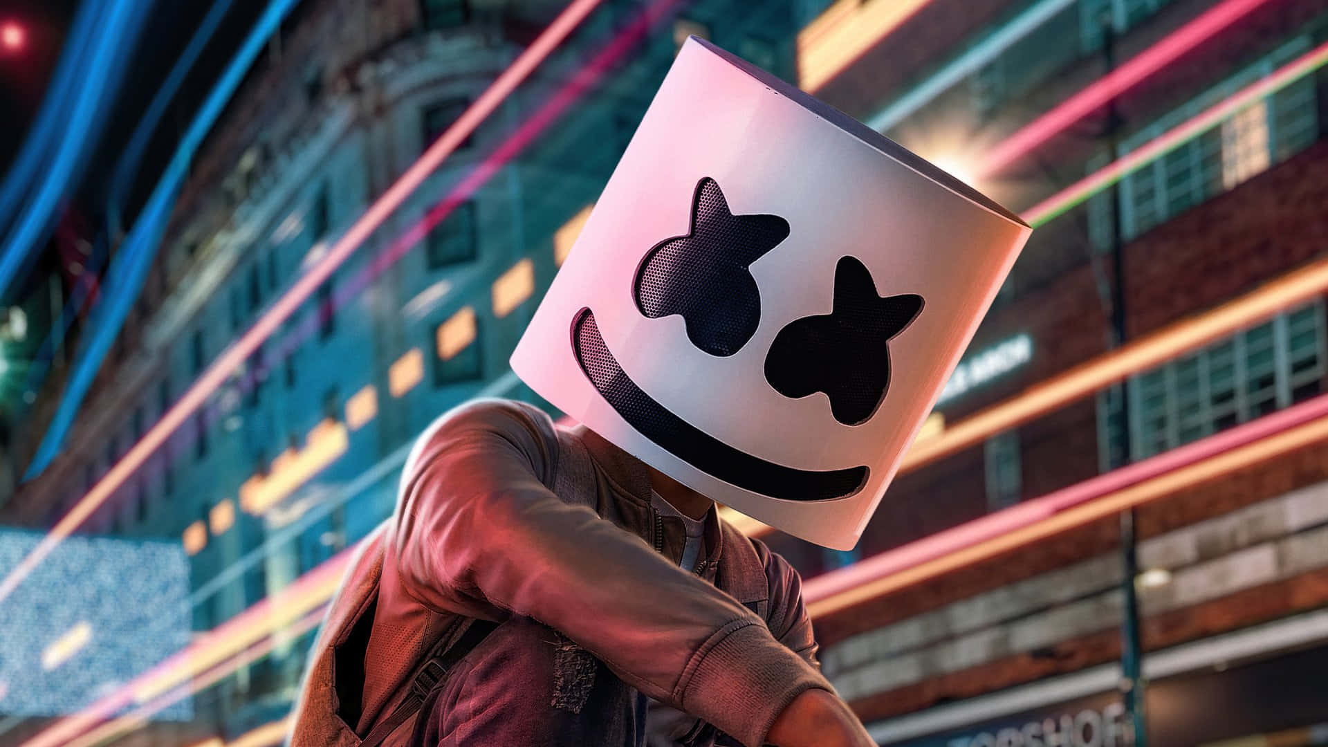 Marshmello 桌布 壁紙 — 一個戴著白色棉花糖面具、有黑色星星眼睛和微笑的人，站在霓虹燈照亮的城市夜景中。