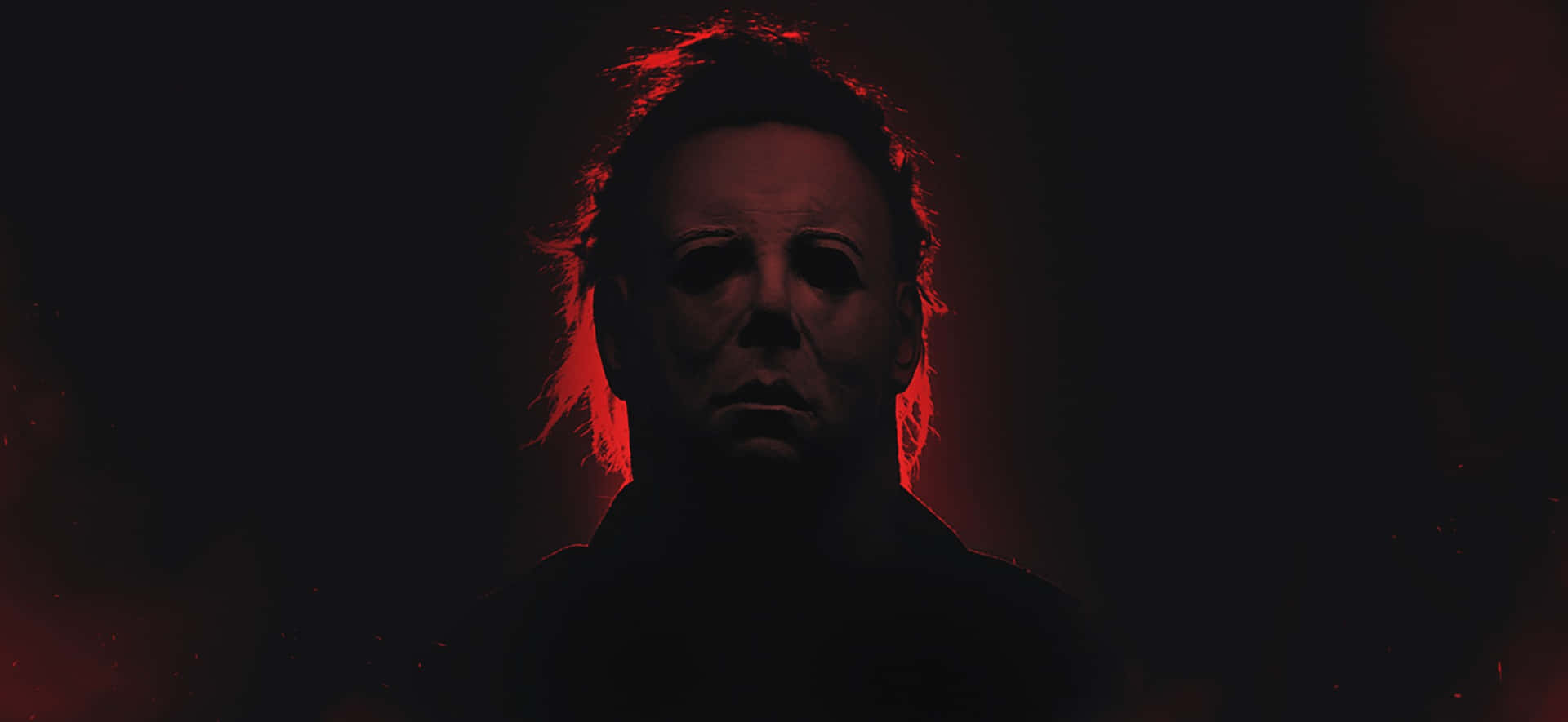 Mike Myers 桌布 壁紙 — 一個戴著白色面具的威脅人物在黑暗背景中發出紅光。