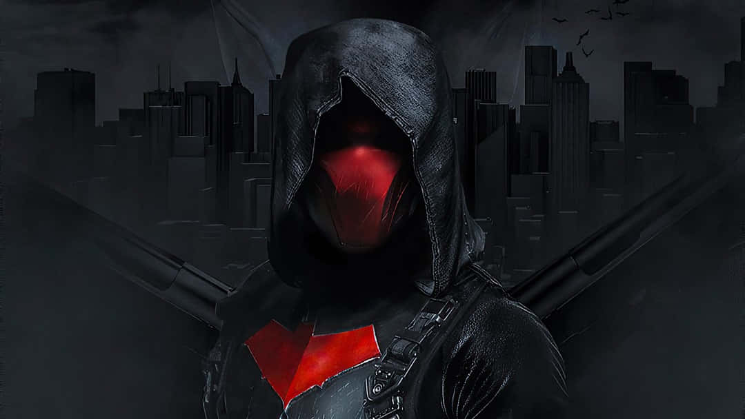 Red Hood 桌布 壁紙 — 一個戴著連帽衫、眼睛發出紅光、胸前有紅色蝙蝠標誌的義警，站在黑暗、霧氣瀰漫的城市天際線前，蝙蝠在頭頂飛翔。