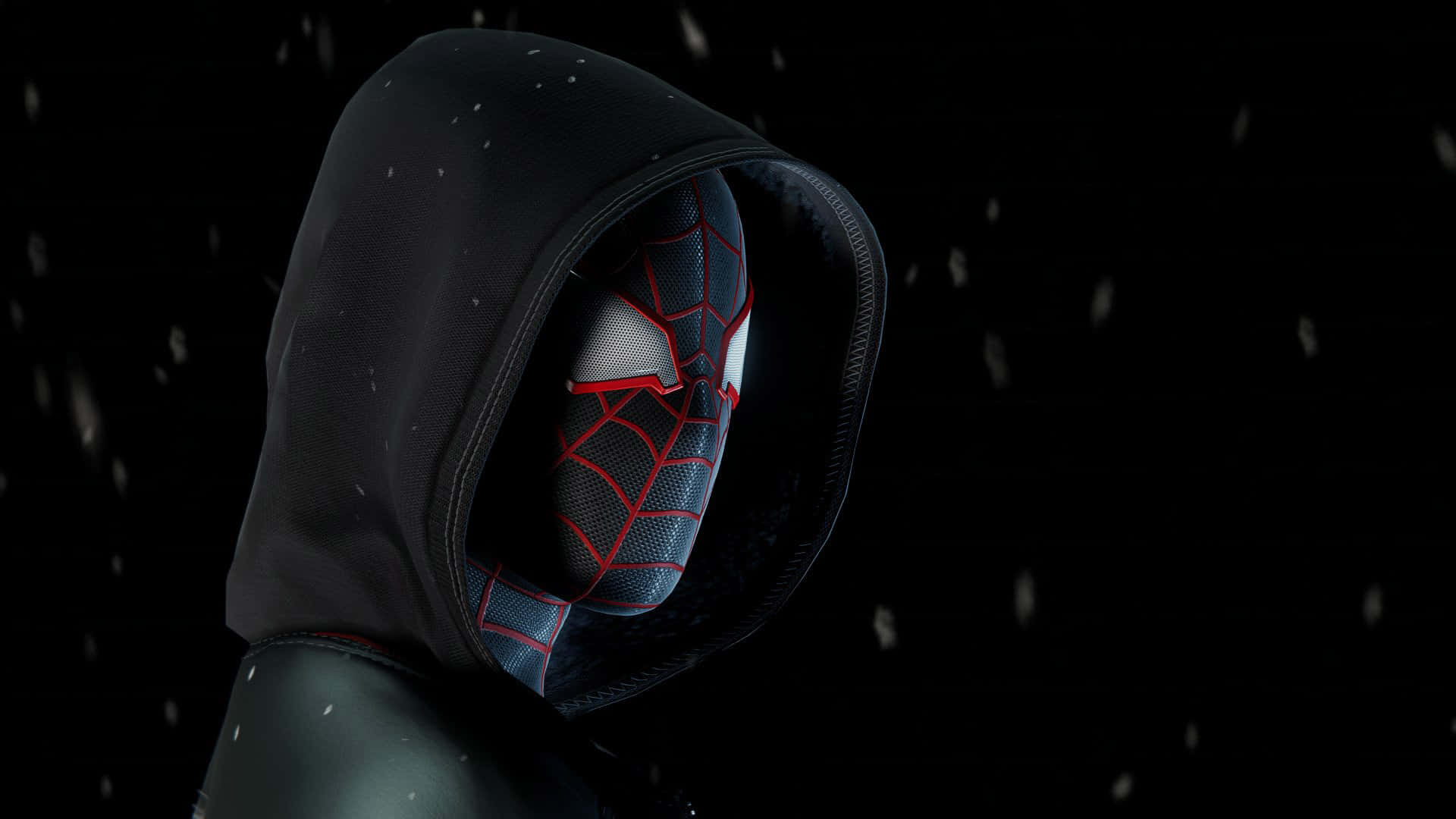 Miles Morales 動漫 桌布 壁紙 — 一個戴著連帽衫的蜘蛛俠，身穿深色連帽衫，站在飄雪中，背景為黑色，面具上有紅色蛛網。