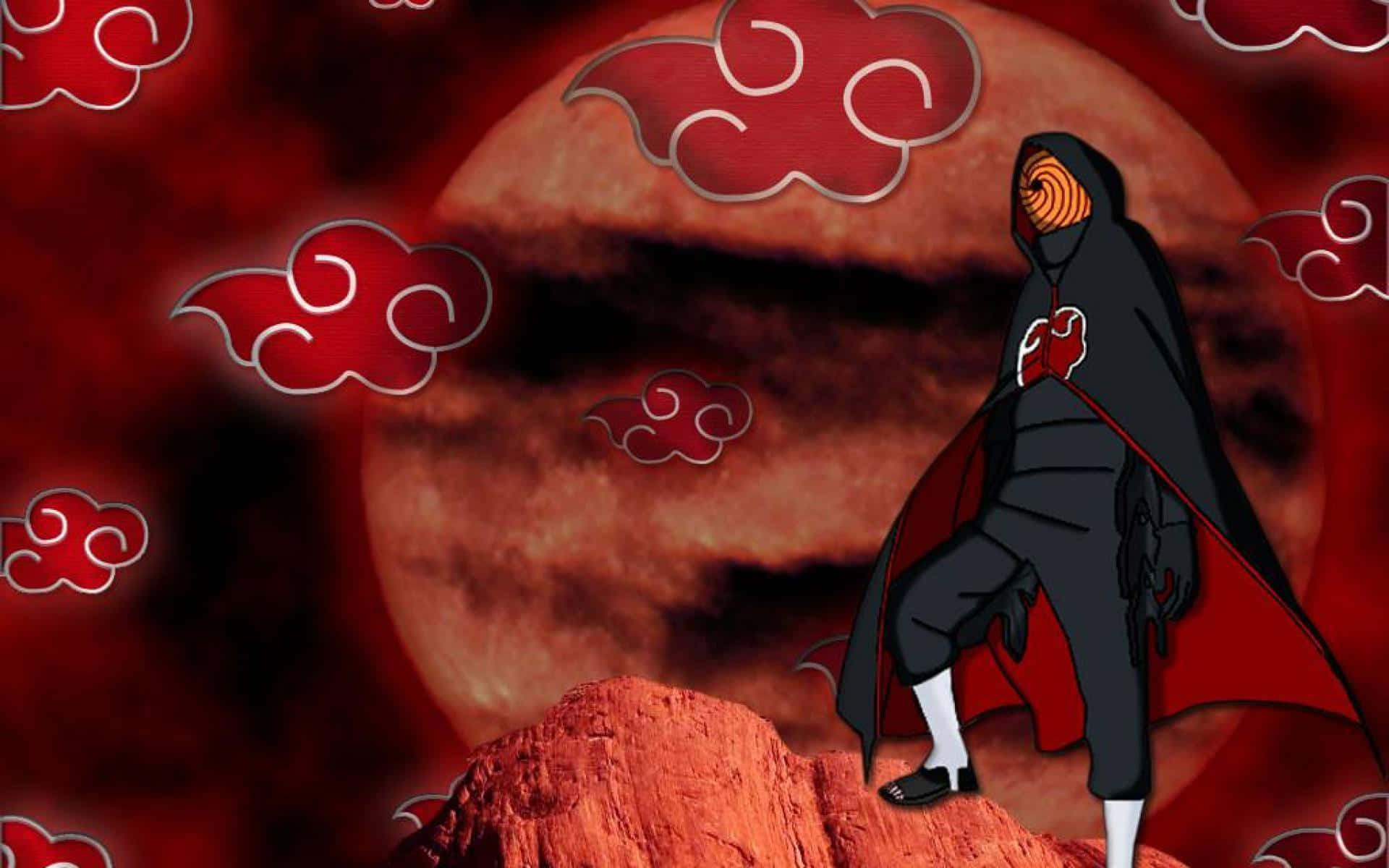 Akatsuki Tobi 桌布 壁紙 — 一個戴面具的忍者，身穿帶有紅色雲紋的黑色斗篷，站在岩石突出處，背景是巨大的紅色月亮。
