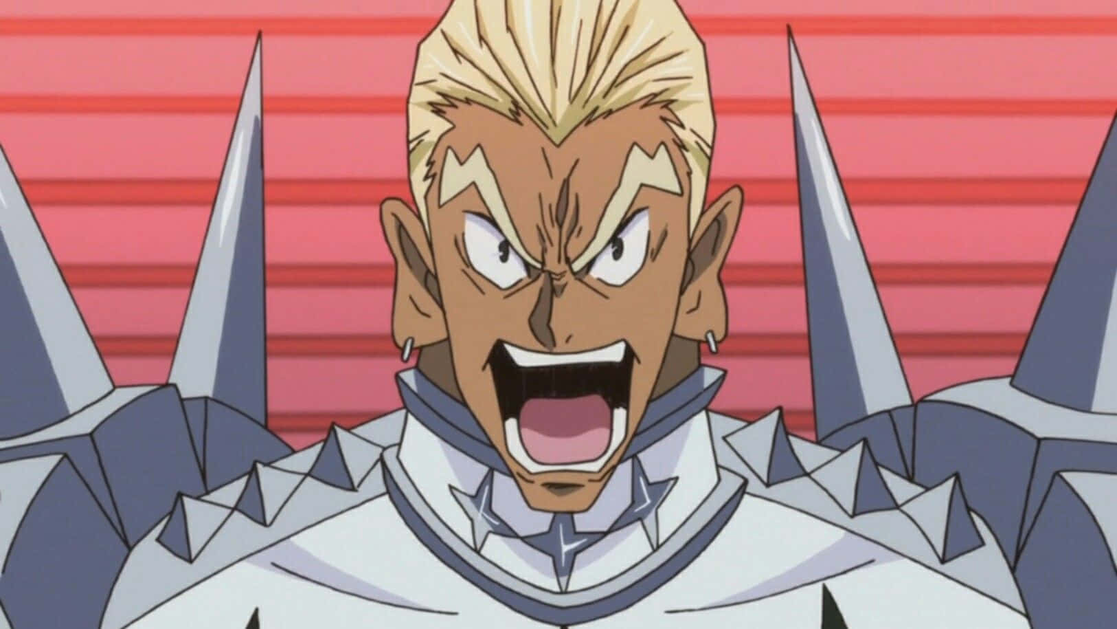 Ira Gamagoori 桌布 壁紙 — 一個擁有尖刺金髮和兇猛表情的動漫戰士，身穿尖刺盔甲，在紅色條紋背景前咆哮。