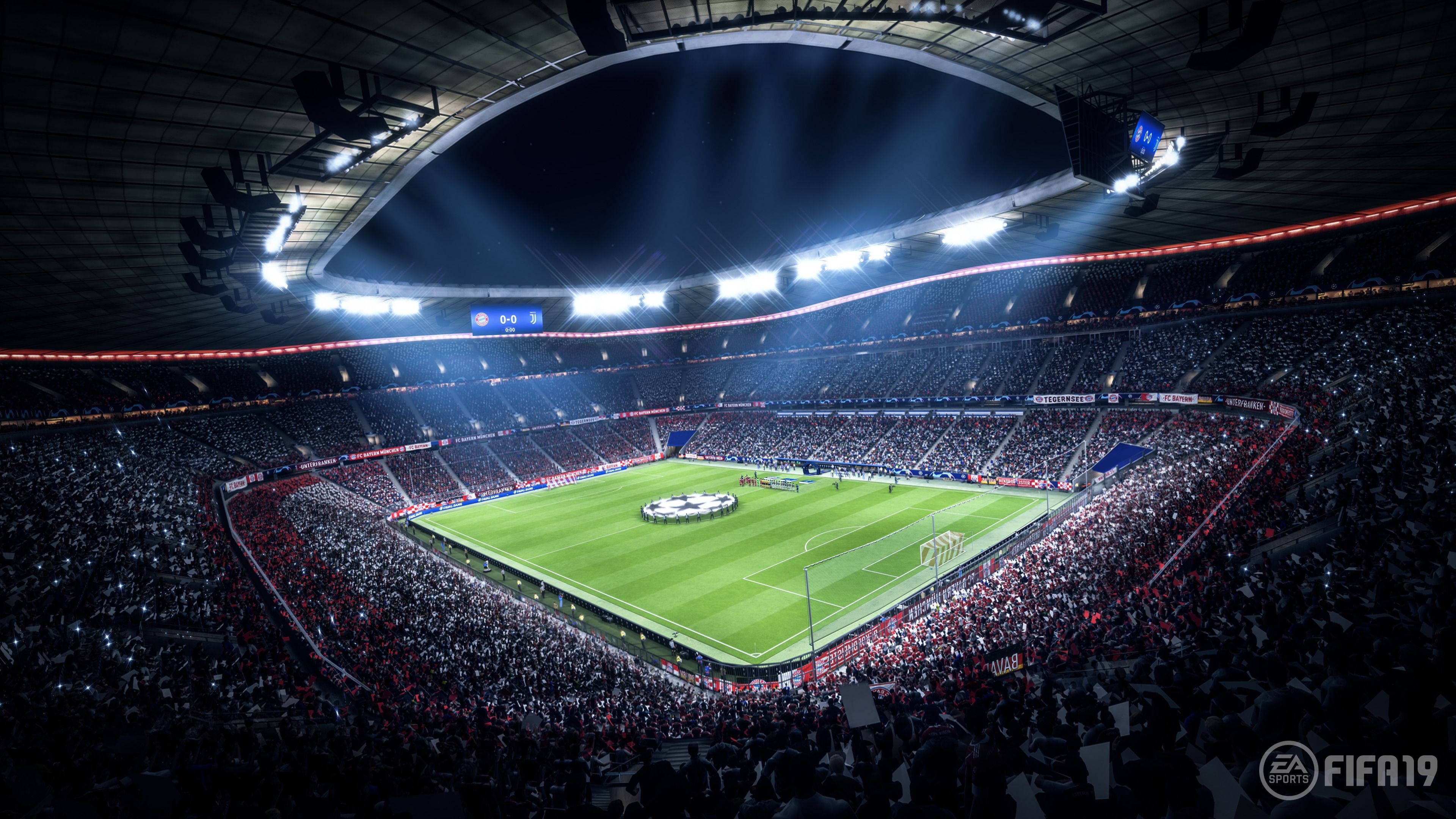 Football Field 桌布 壁紙 — 一個擠滿觀眾的夜間足球場，被明亮的泛光燈照亮，擁有充滿活力的綠色草坪和歡呼的球迷。