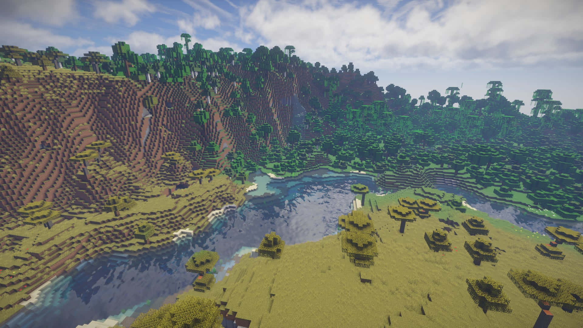 Minecraft Mods 桌布 壁紙 — 一個方塊狀的Minecraft景觀，有起伏的山丘、森林和蜿蜒的河流，天空部分多雲。
