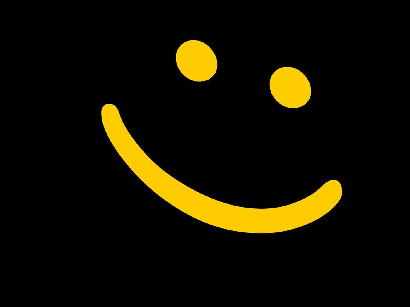 Smiley 桌布 壁紙 — 一個明亮的黃色笑臉，帶有簡單的點狀眼睛，在純黑色背景上格外突出。