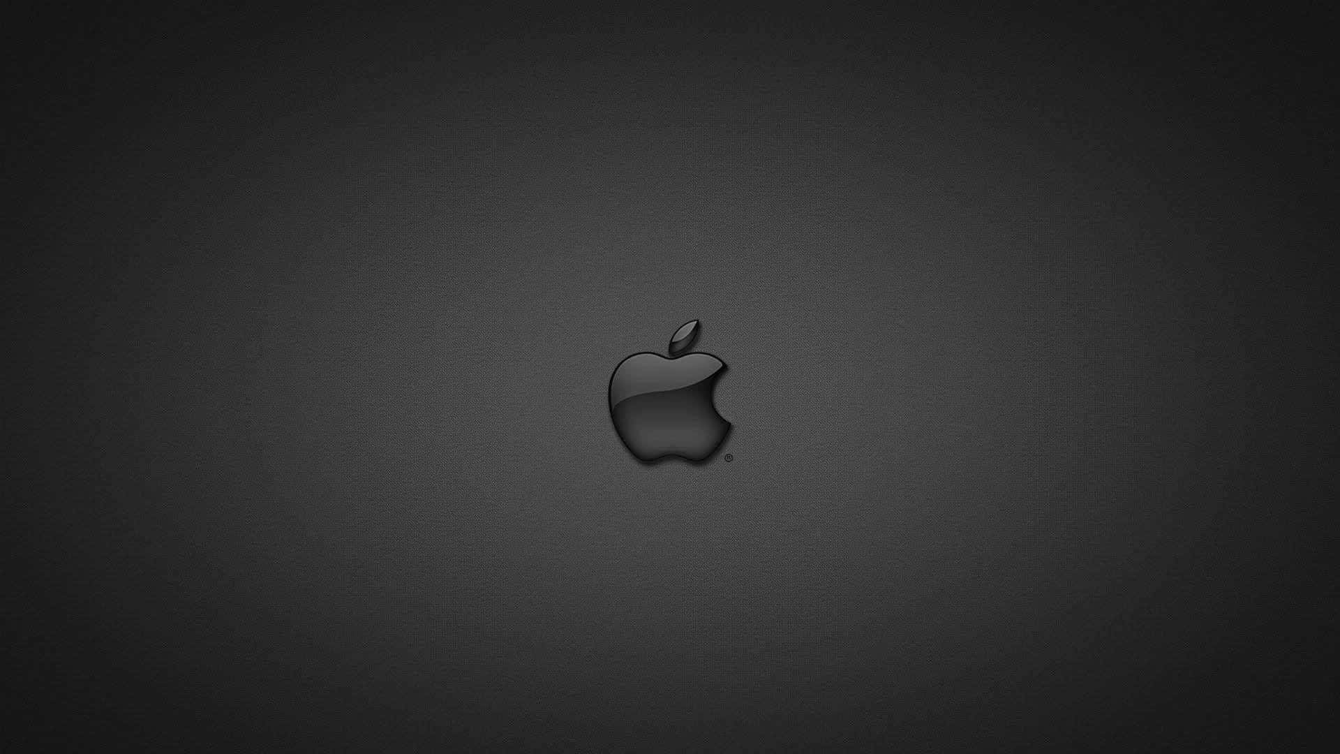 Matte 桌布 壁紙 — 一個時尚的黑色Apple標誌，置於帶有柔和照明的深色漸變背景中央。