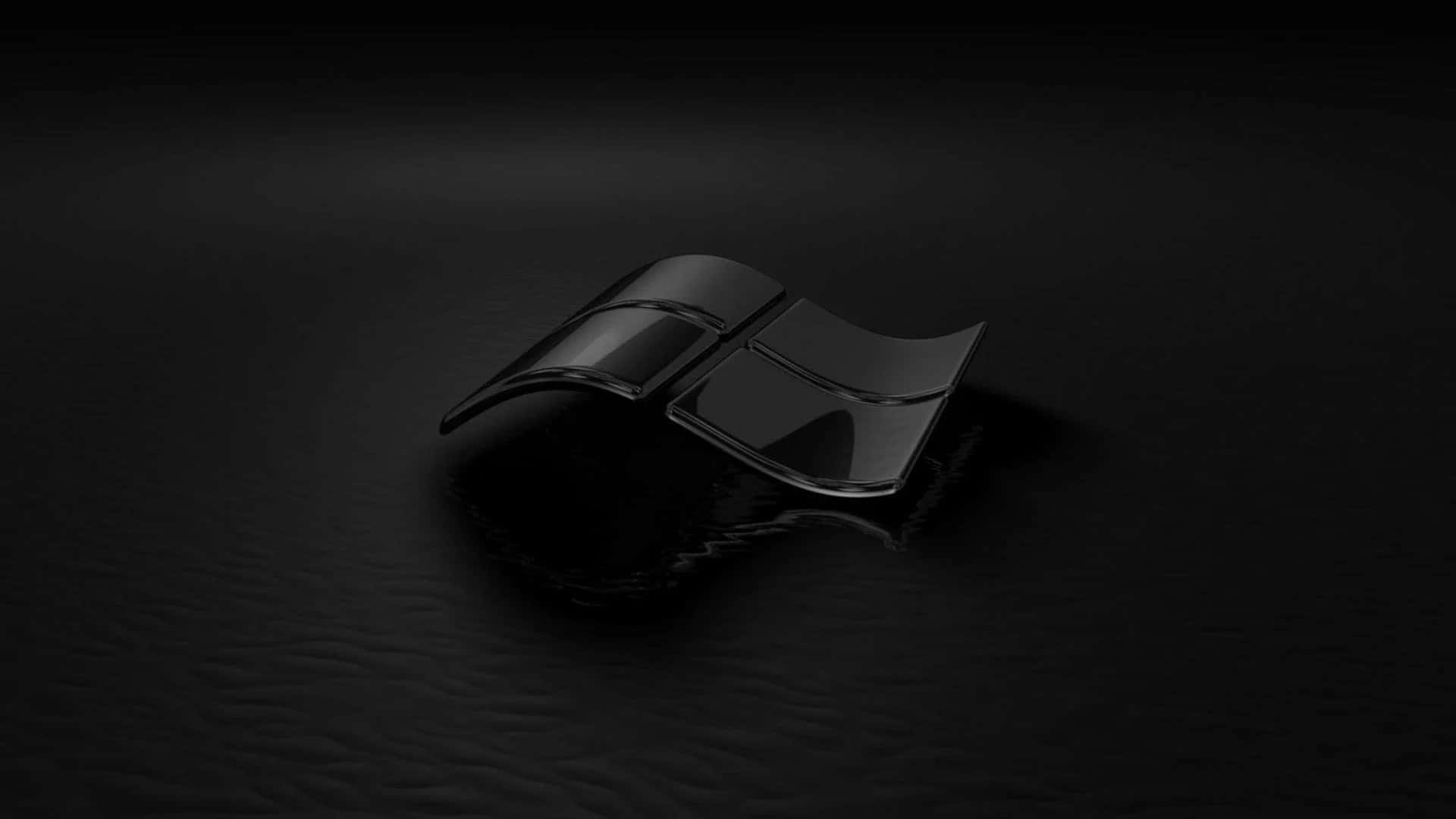Black Windows 桌布 壁紙 — 一個時尚的黑色Windows標誌放置在深色紋理表面上，柔和的光線突顯其光亮的曲線。
