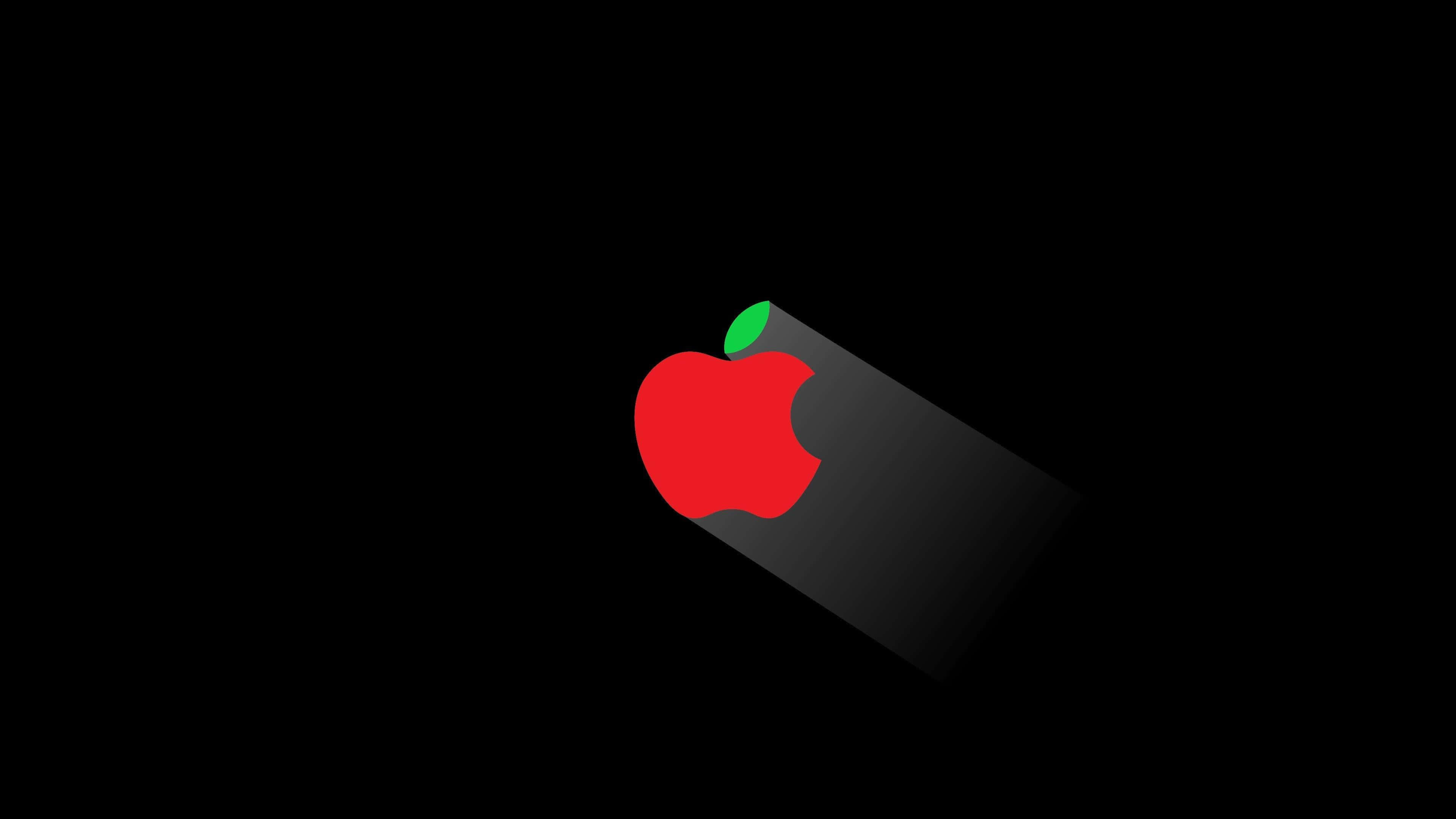 4K Apple 桌布 壁紙 — 一個極簡的紅色蘋果標誌，帶有綠色葉子，在黑色背景上投下長長的陰影。