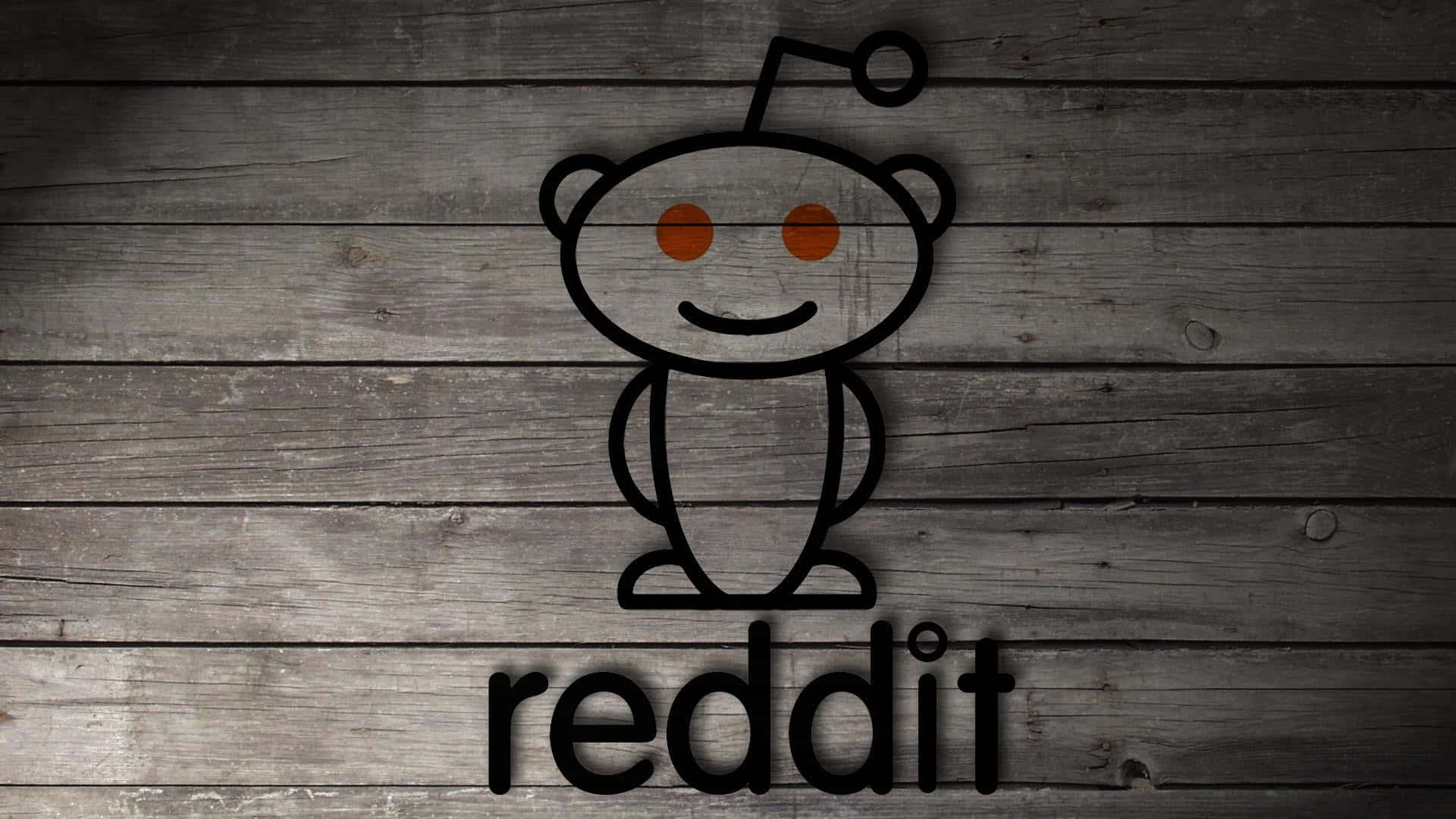 reddit 桌布 壁紙 — 一個極簡的黑色輪廓Reddit外星人吉祥物，橙色眼睛，坐在灰色風化木板上，下方有reddit字樣。