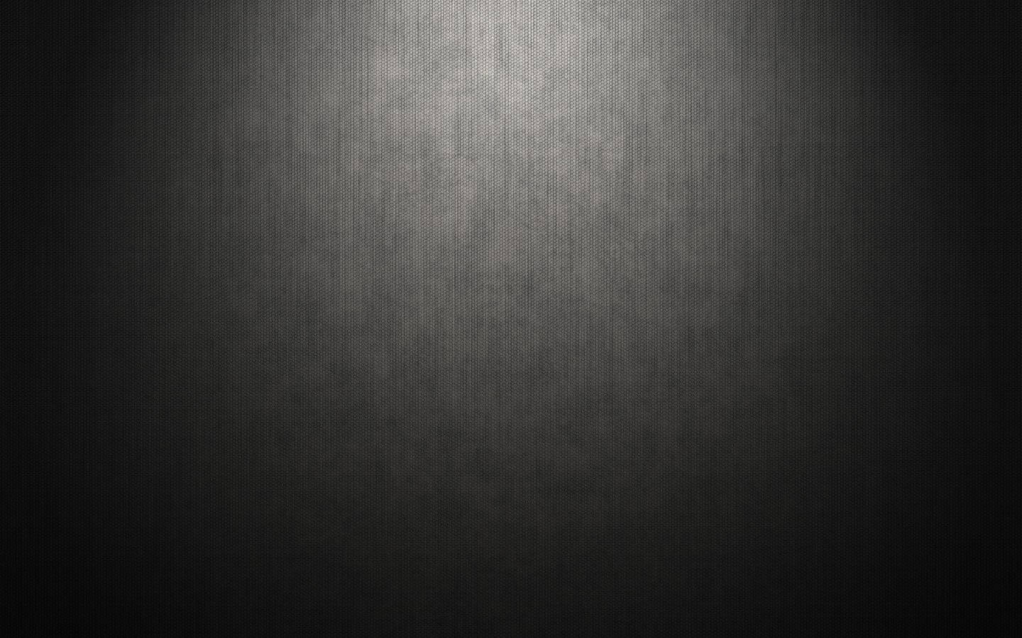 Dark Wall 桌布 壁紙 — 一個深色紋理表面，由柔和聚光燈照亮，形成從明亮中心到深陰影的漸變。