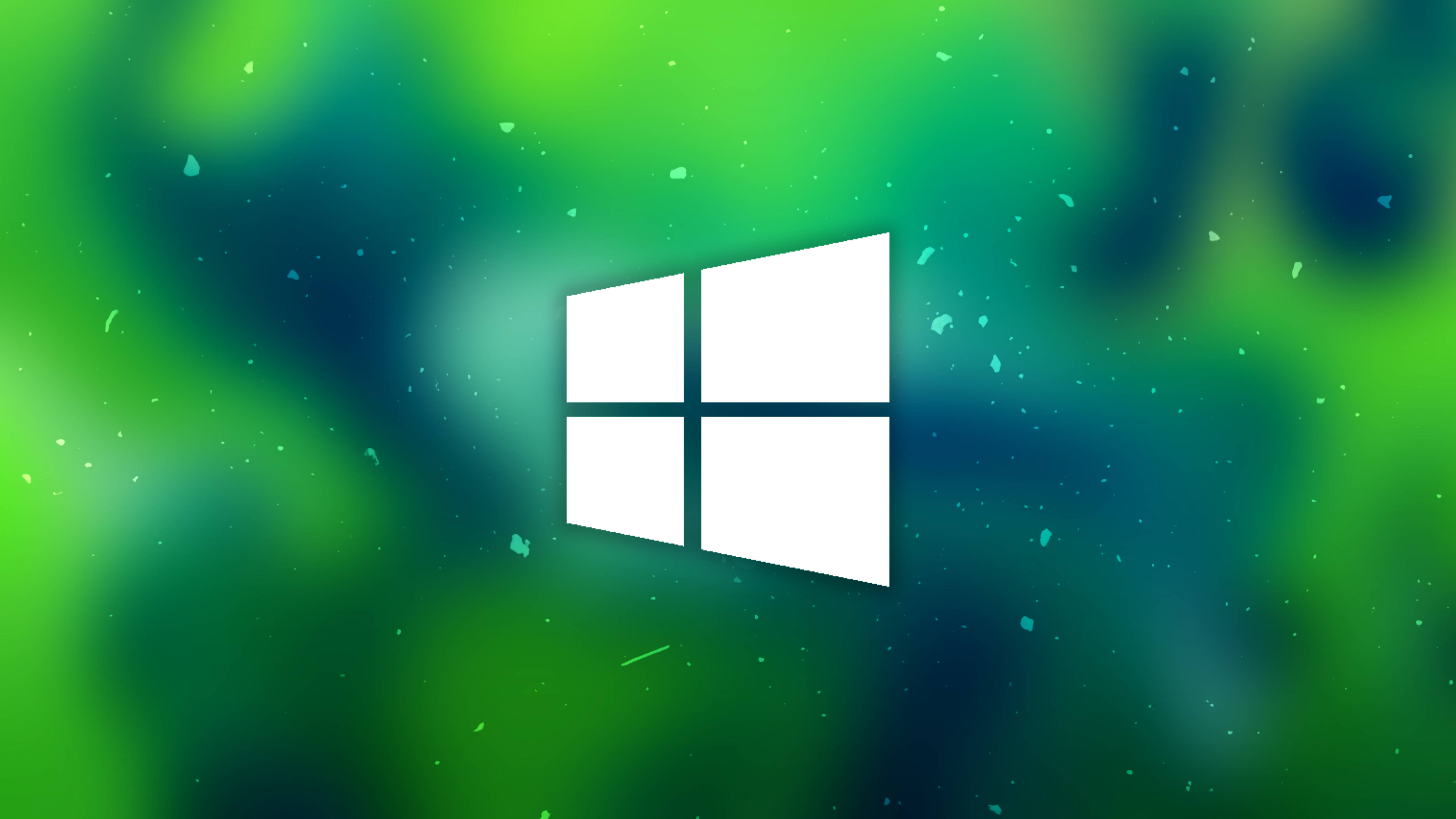 Windows Computer 桌布 壁紙 — 一個清晰的白色Windows標誌漂浮在充滿活力的綠色和藍綠色模糊背景上，帶有漂浮的粒子。