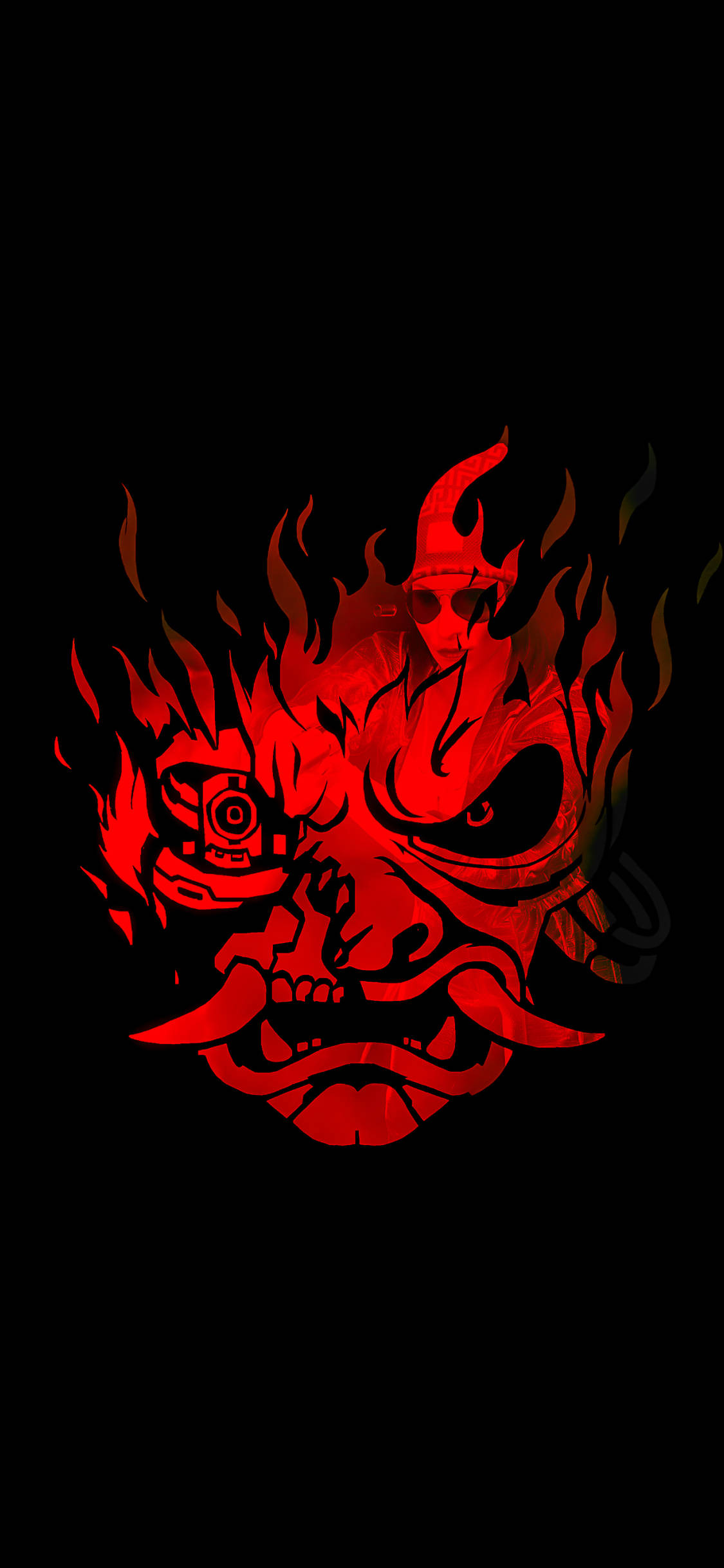 惡魔 桌布 壁紙 — 一個火紅色的惡魔面具，帶有發光的眼睛和火焰般的頭髮，背景為黑色。
