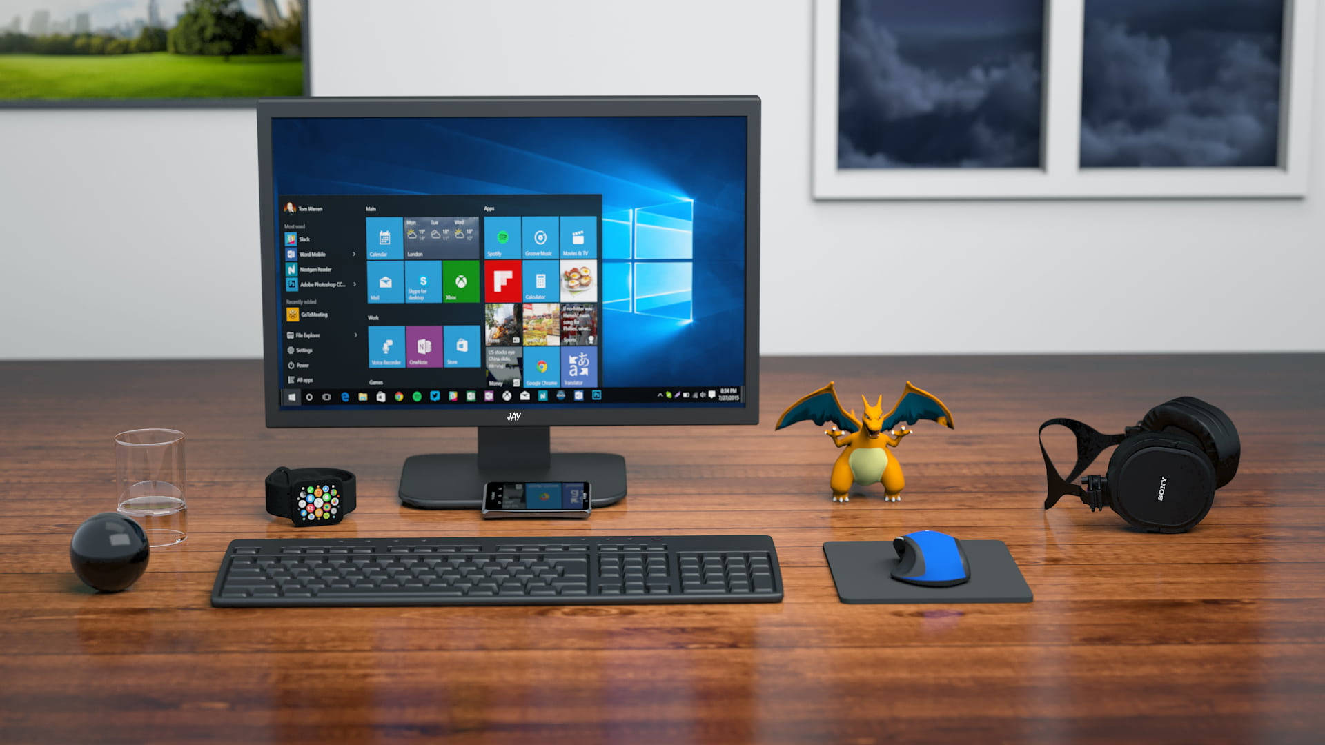 microsoft 桌布 壁紙 — 一個現代木質辦公桌設置，配備顯示開始功能表的Windows電腦顯示器，周圍環繞著遊戲裝備和科技小工具。