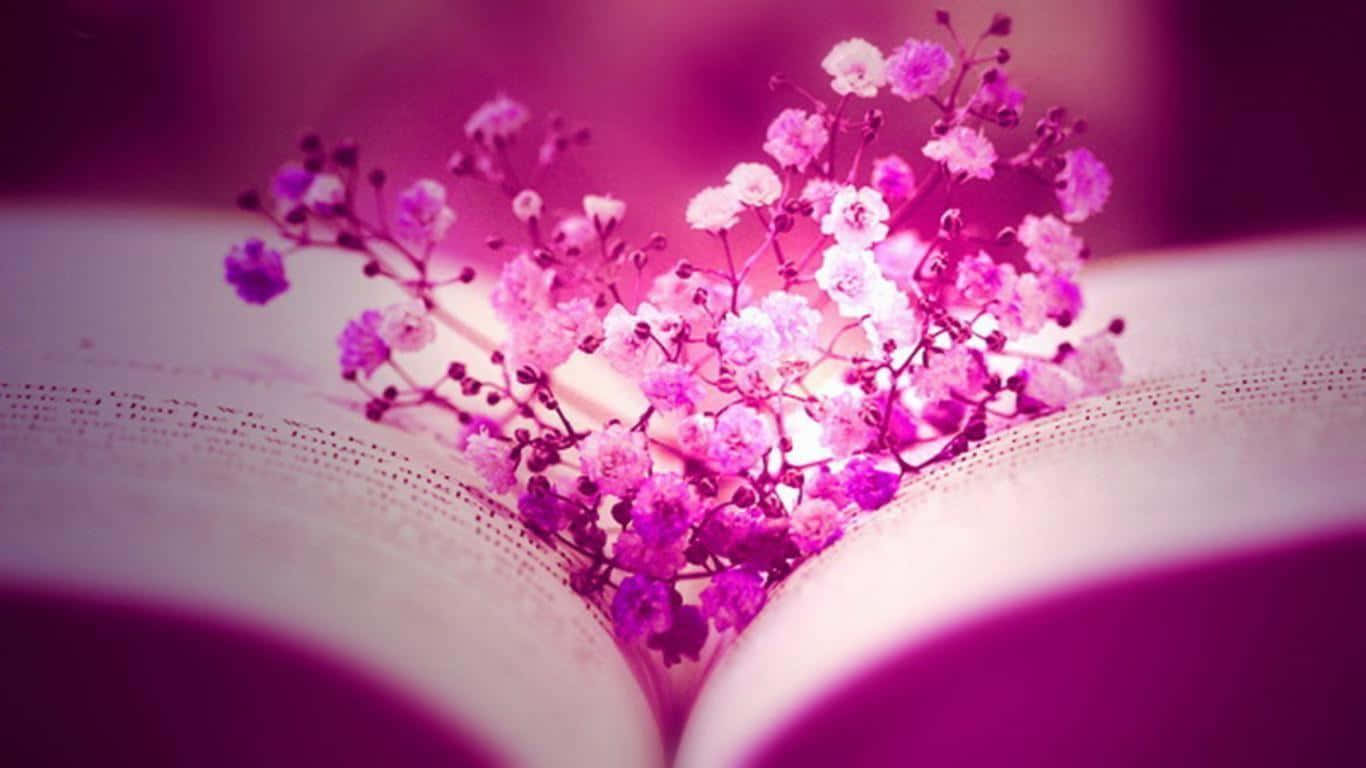 Facebook Cover 桌布 壁紙 — 一個由粉紅色和白色滿天星花朵組成的心形花藝，輕輕地放在一本沐浴在柔和紫色光線中的打開的書頁上。