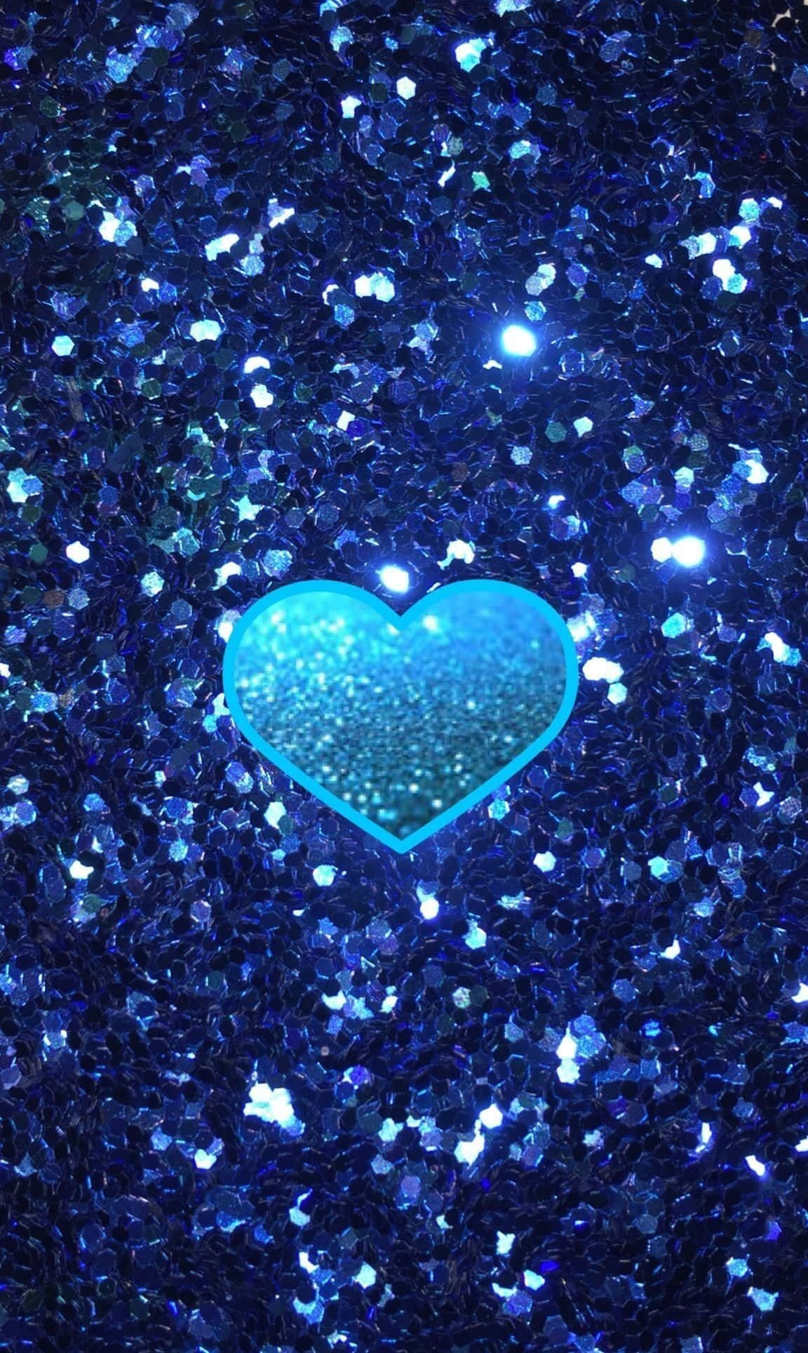 Blue Heart 桌布 壁紙 — 一個由閃粉製成的發光青色心形，放置在閃爍深藍色閃粉的場地上。