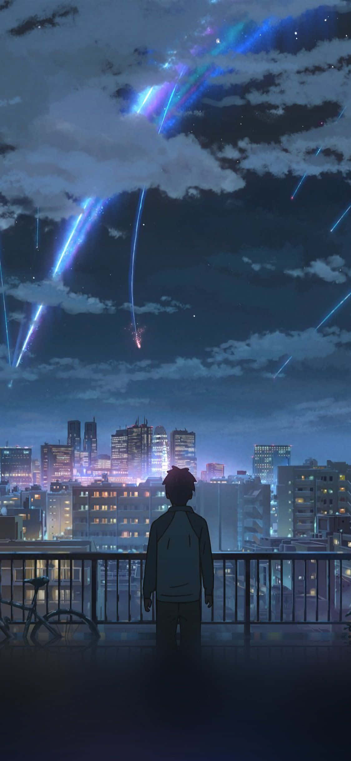 一個男人俯瞰夜晚嘅城市 壁紙