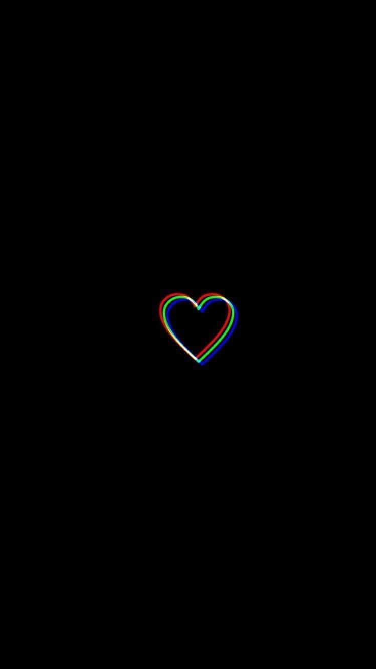 Black And White Heart 桌布 壁紙 — 一個發光嘅彩虹輪廓心臟喺純黑色背景上柔和地脈動。