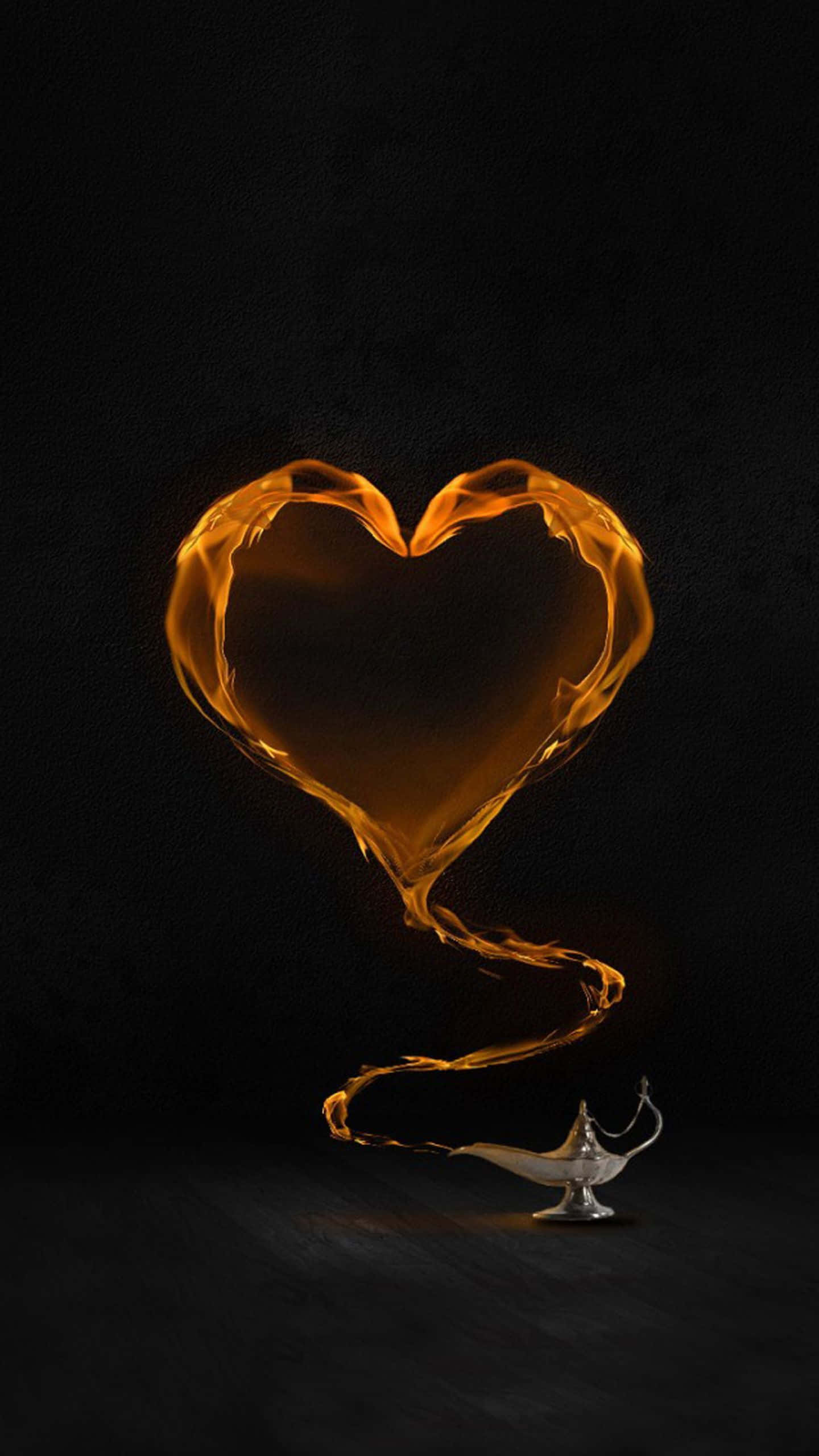 Yellow Heart 桌布 壁紙 — 一個發光的橙色心形火焰從銀色神燈中升起，背景為黑色。