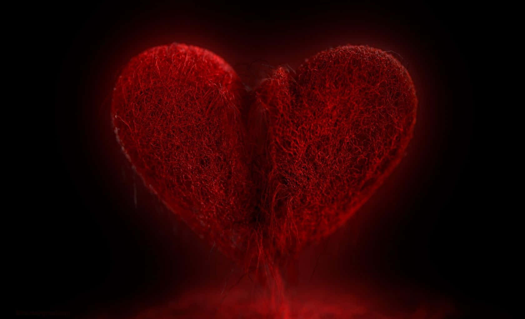 Broken Heart Black 桌布 壁紙 — 一個發光的紅色紋理心臟在深黑色背景上溫暖地跳動。