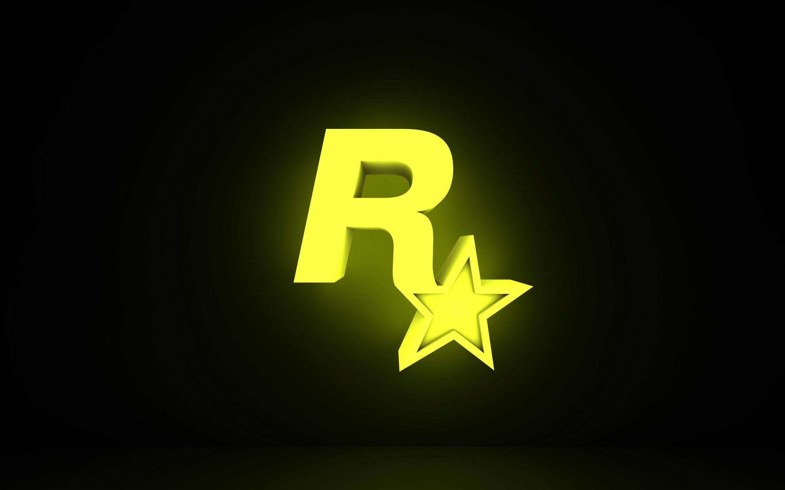 Gamer Logo 桌布 壁紙 — 一個發光的黃色Rockstar Games標誌，帶有一顆星星，在深色漸變背景上閃耀。