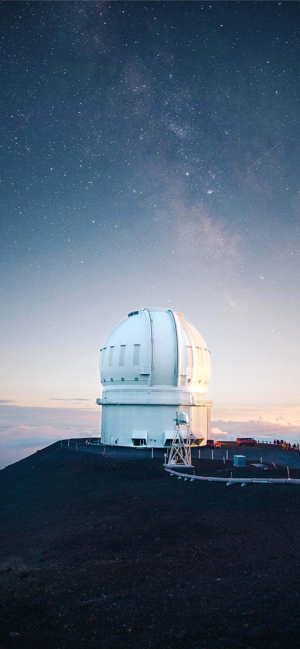 Space Observation 桌布 壁紙 — 一個白色天文台圓頂矗立在黑暗的火山頂上，上方是繁星點點的夜空，銀河拱起。