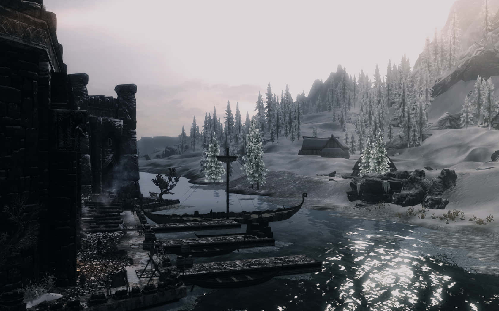 Skyrim Windhelm 桌布 壁紙 — 一個白雪覆蓋的山村，有冰封的河流和古老的石頭遺跡，在蒼白的冬日天空下。