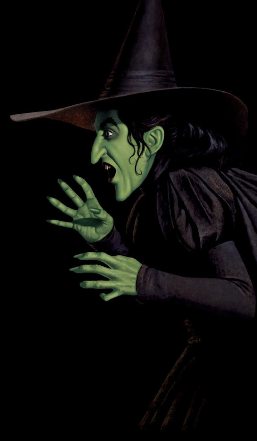 Evil Witch 桌布 壁紙 — 一個皮膚呈綠色、戴著尖帽子的可怕女巫，在黑色背景前尖叫，雙手向前抓。