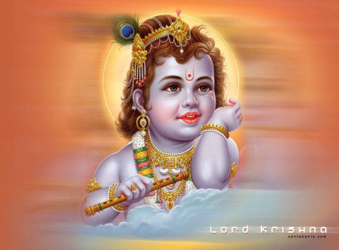 Indian 桌布 壁紙 — 一個神聖的孩子，捲曲的頭髮和金色飾物，坐在雲端上，手持長笛，背景是溫暖發光的日落。