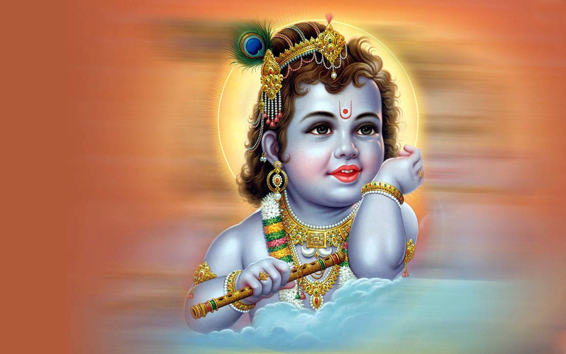 Krishna 桌布 壁紙 — 一個神聖的孩子，藍色皮膚，戴著金色皇冠，坐在雲端上，手持長笛，背景是耀眼的橙色。