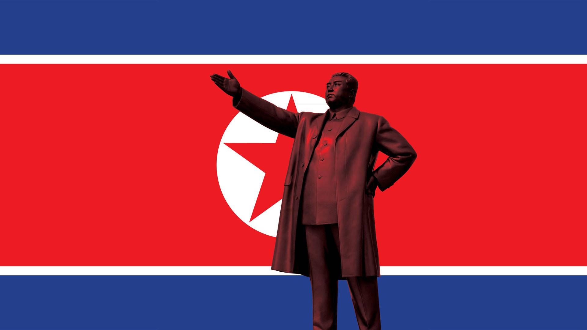 North Korea 桌布 壁紙 — 一個穿著深色外套的男人雕像，在北韓國旗背景下舉起一隻手臂。