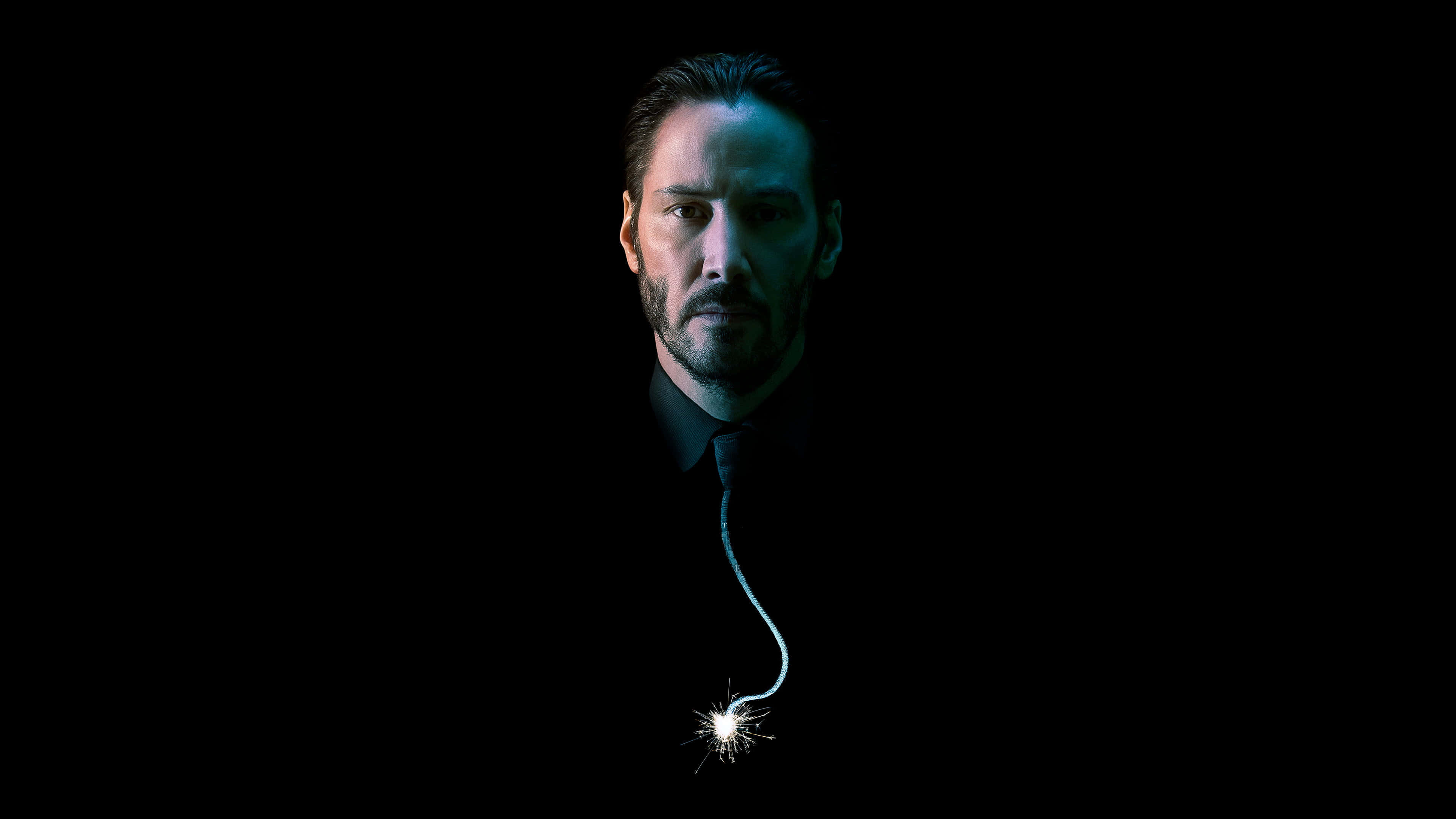 Keanu Reeves 桌布 壁紙 — 一個穿著深色西裝的男人在黑色背景前凝視著，領帶上懸掛著一個點燃的煙花棒。