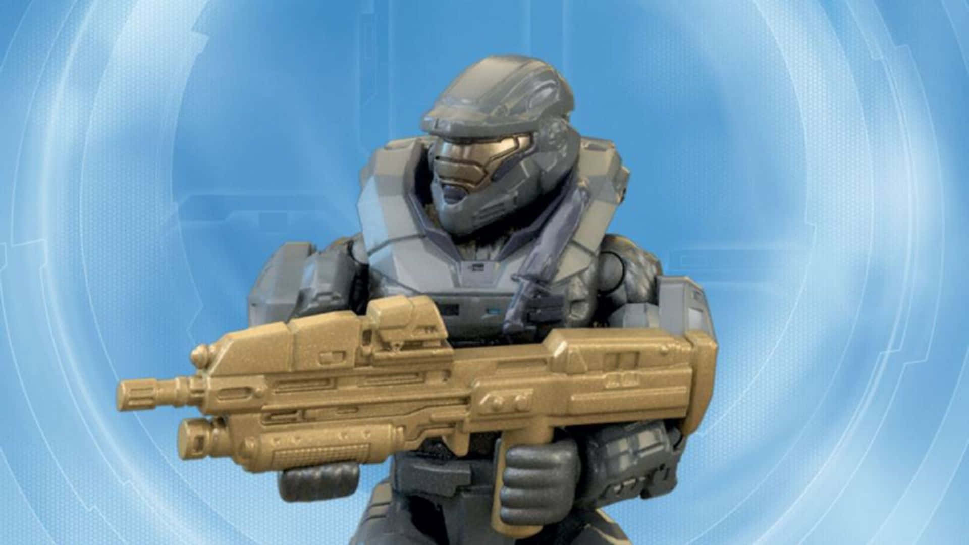 Noble Six 桌布 壁紙 — 一個穿著灰色盔甲的Halo Master Chief可動人偶，手持金色能量步槍，背景為藍色未來風格。