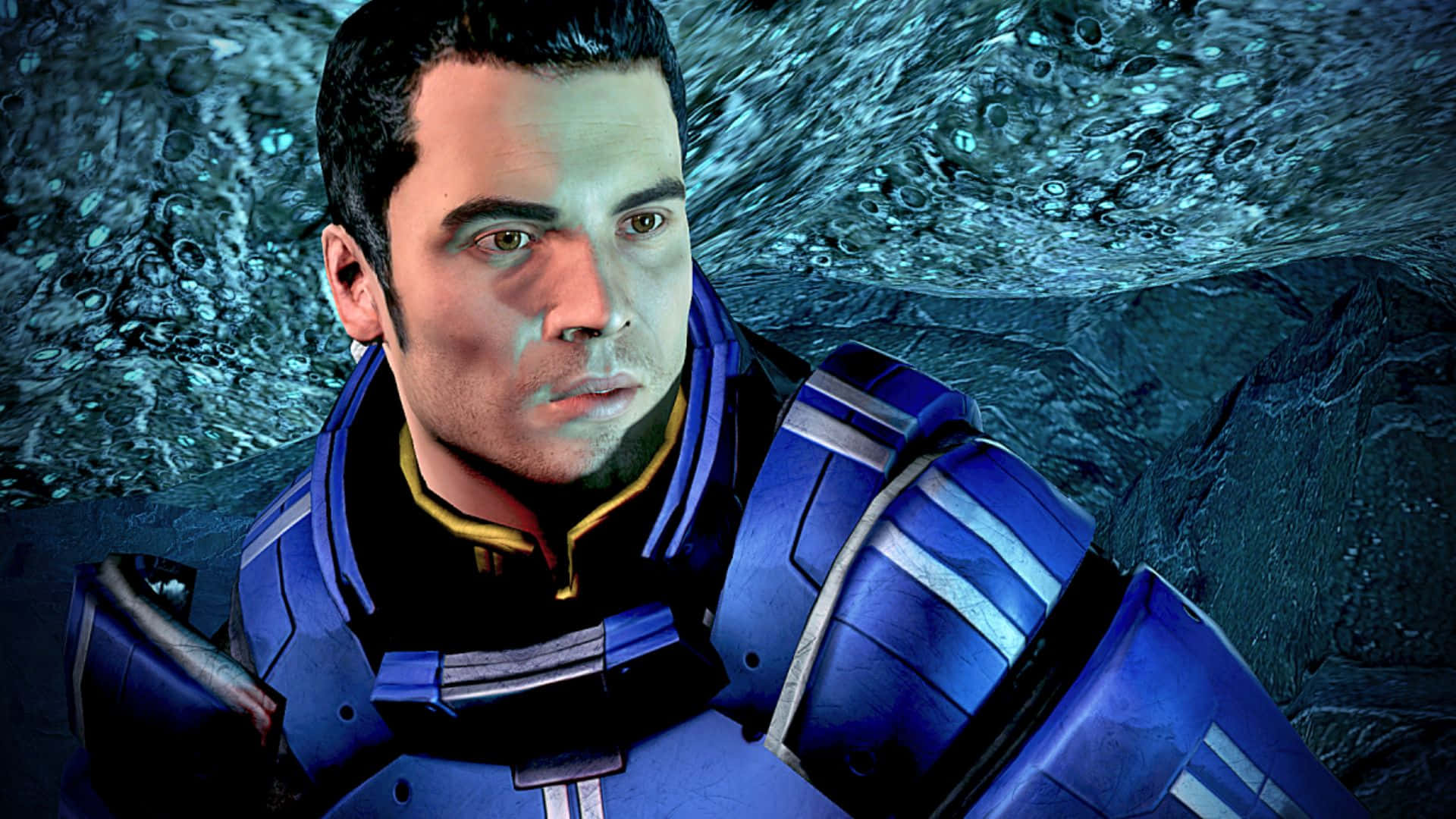 Kaidan Alenko 桌布 壁紙 — 一個穿著藍色裝甲裝備的嚴肅男人站在有紋理的青綠色外星岩石牆前。