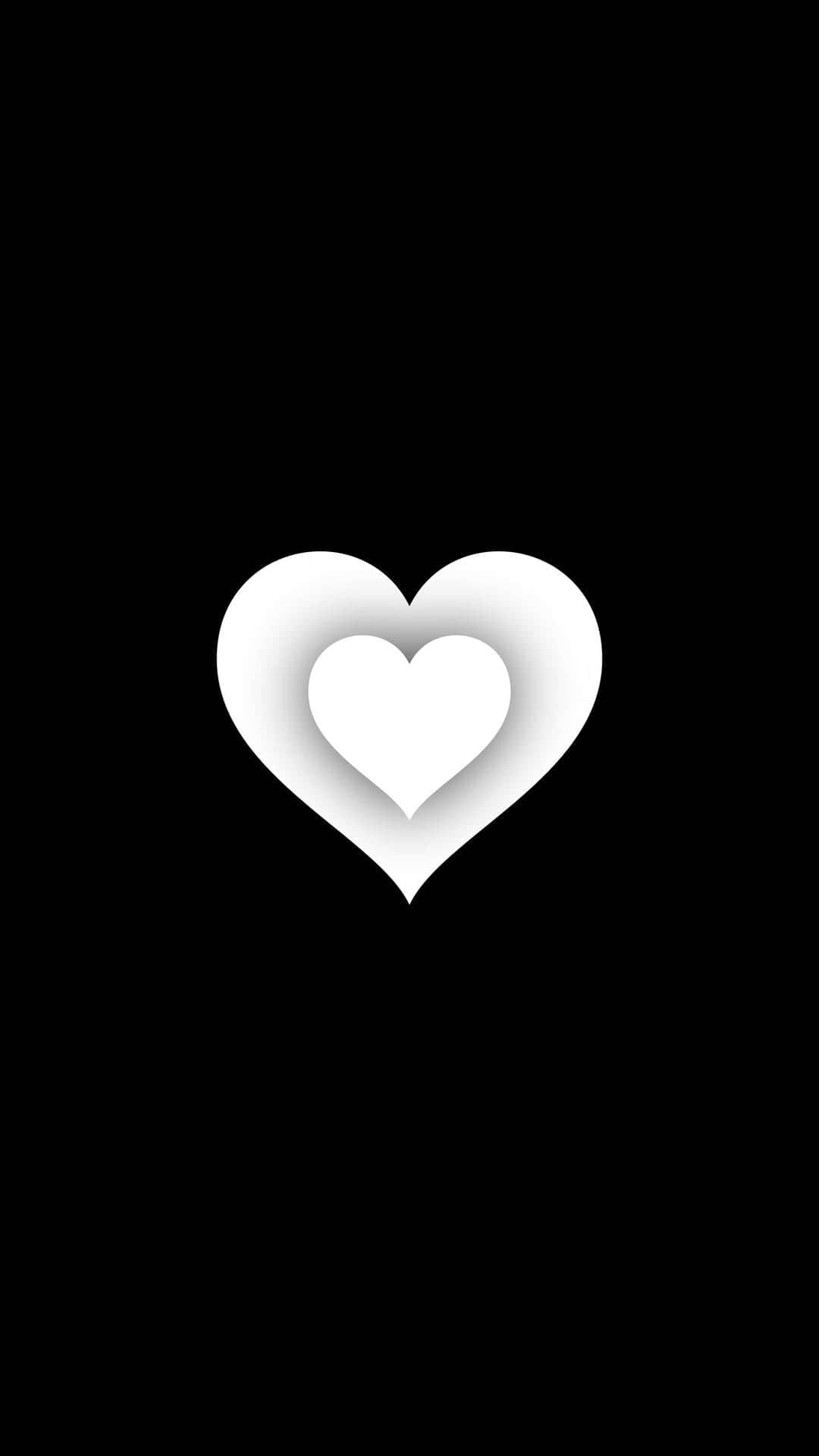 Black And White Heart 桌布 壁紙 — 一個簡約的白色心形，內含一個較小的心形，在純黑色背景上投射出柔和陰影。