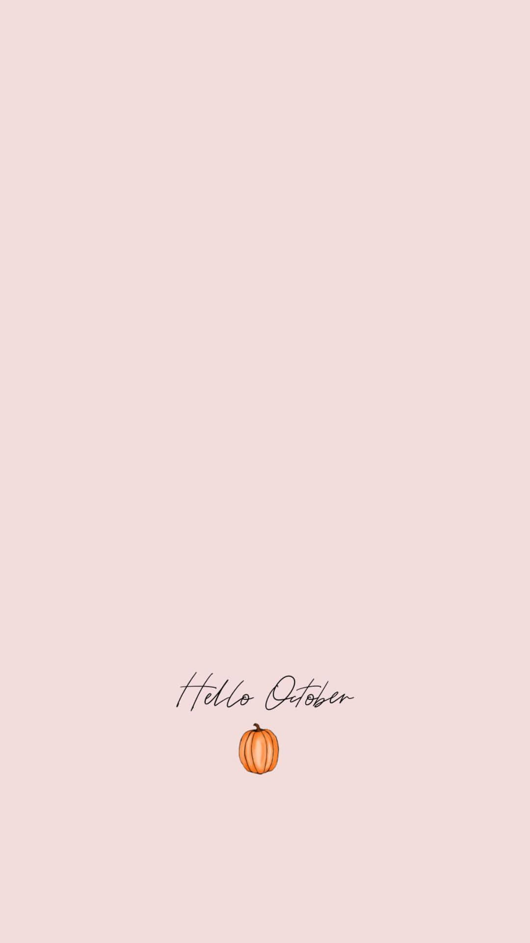 蜜桃色背景上帶有 Hello October 文字和一個小南瓜。 — 粉紅色 iPhone 壁紙