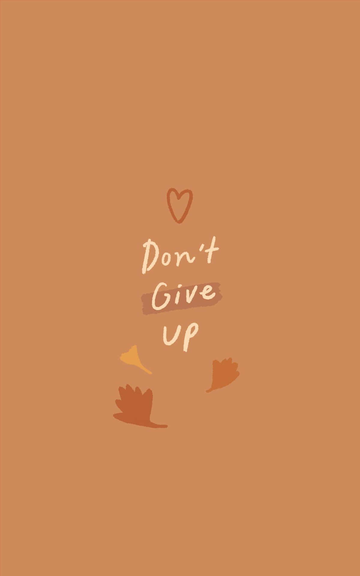 Anxiety iPhone 桌布 壁紙 — 一個簡約的陶土色背景，上面有白色手寫體 'Don't Give Up' 字樣，配以一個心形和飄落的秋葉。