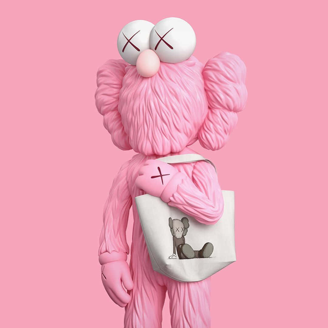 Kaws Bff Pink 桌布 壁紙 — 一個粉紅色的KAWS角色，眼睛交叉，手持一個白色托特包，上面有較小的KAWS圖案，背景為純粉色。