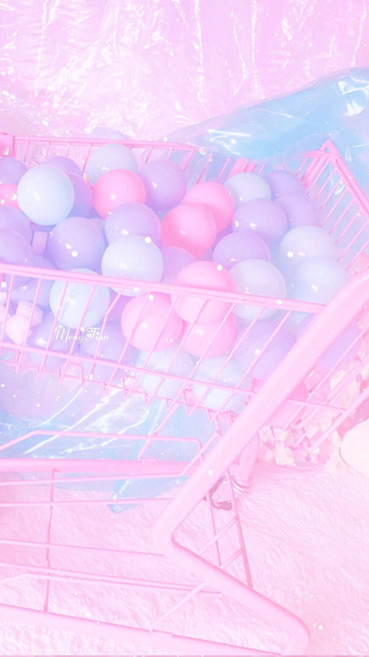 Balloons 桌布 壁紙 — 一個粉紅色購物車，裝滿柔和的紫色和藍色球，在夢幻般的粉紅薄霧下。