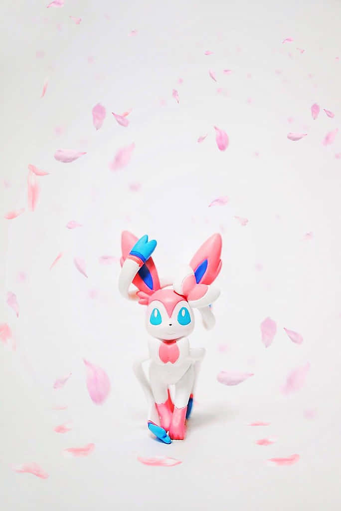 Pokemon Figures 桌布 壁紙 — 一個粉藍色嘅Sylveon公仔企喺柔軟白色背景上嘅飄落櫻花花瓣之間。
