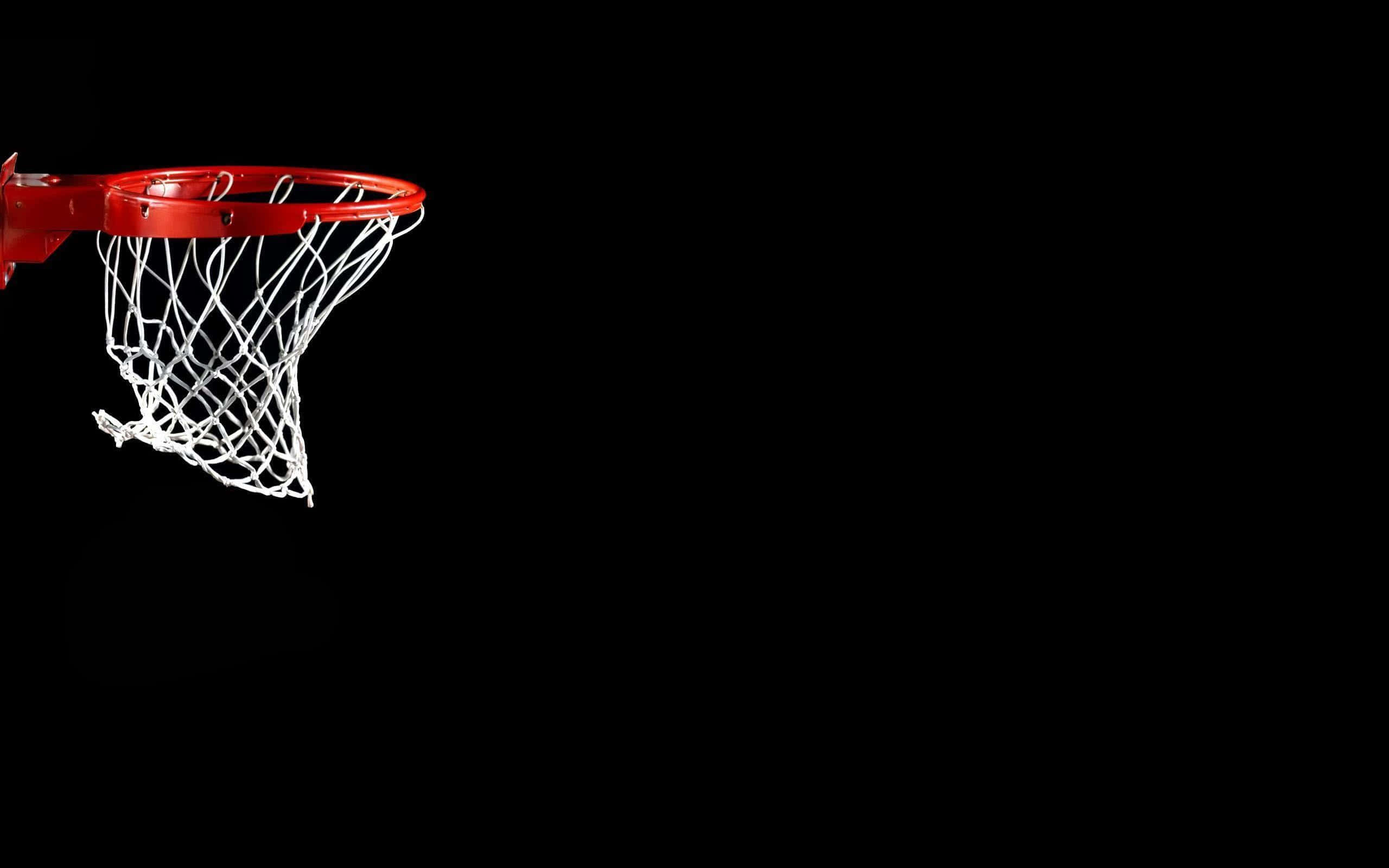 Cool Basketball 桌布 壁紙 — 一個紅色籃球框配白色網，在純黑色背景上孤立展示。
